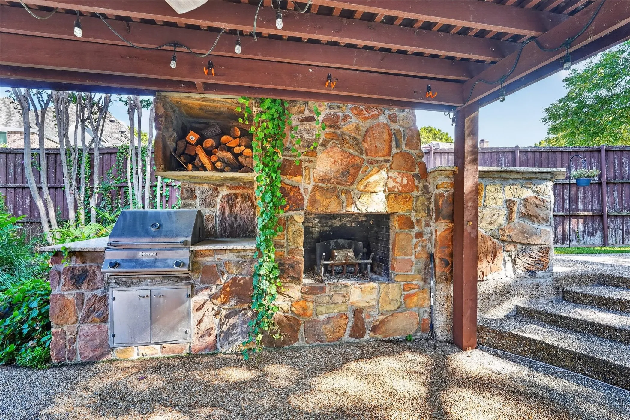 Outdoor Kitchen, Stone Fireplace, pergola, and Bar