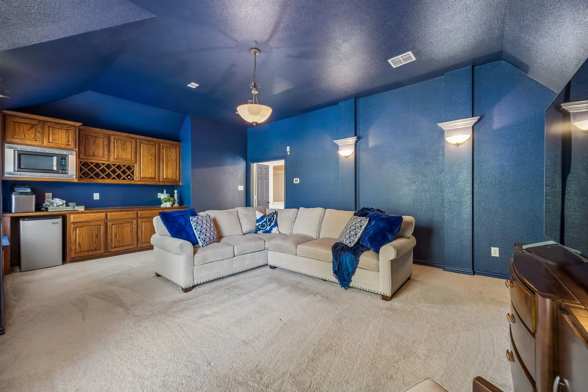 Media room over garage with microwave and space for a mini fridge