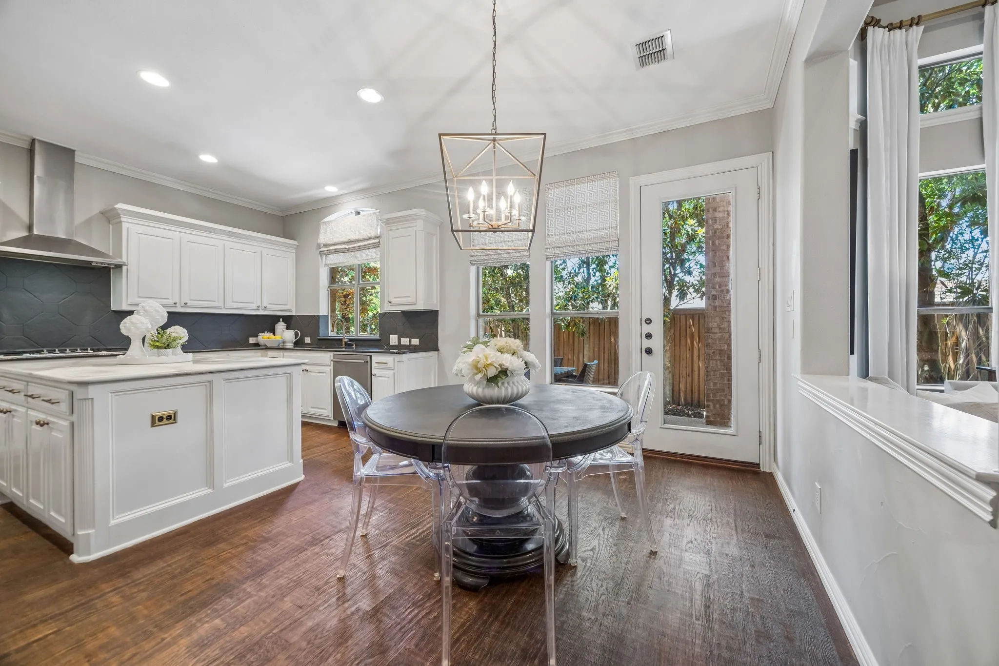 Eating nook in kitchen with designer light fixture