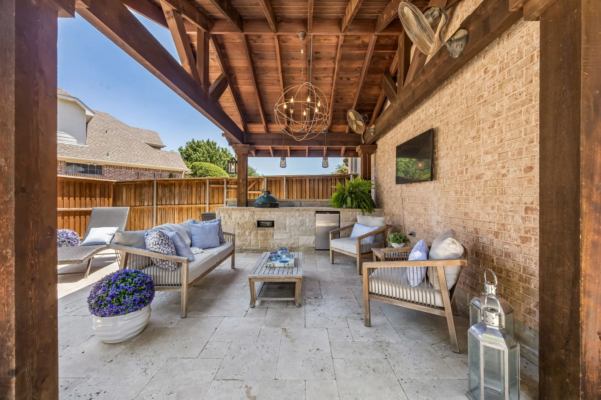 Large travertine patio with multiple fans, mini fridge, and Green Egg for an afternoon barbeque