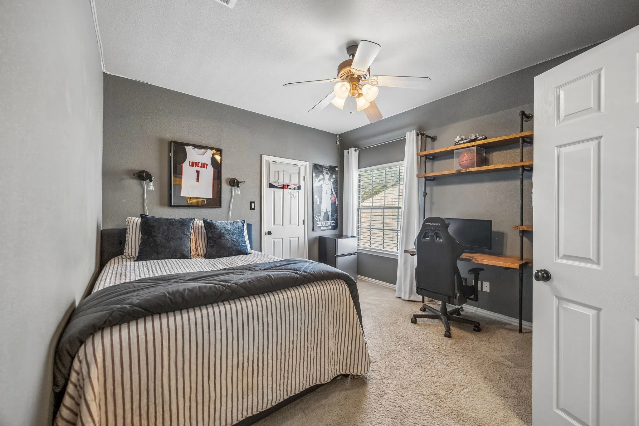 Secondary bedroom with custom desk and shelving