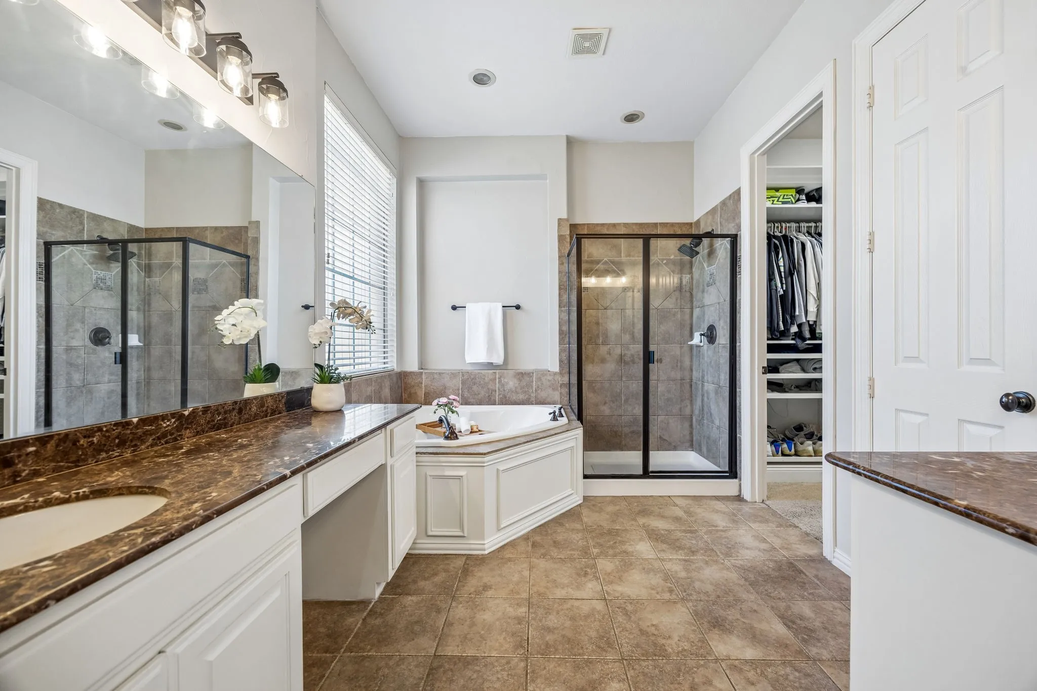 Primary bathroom with jetted tub and dual vanities