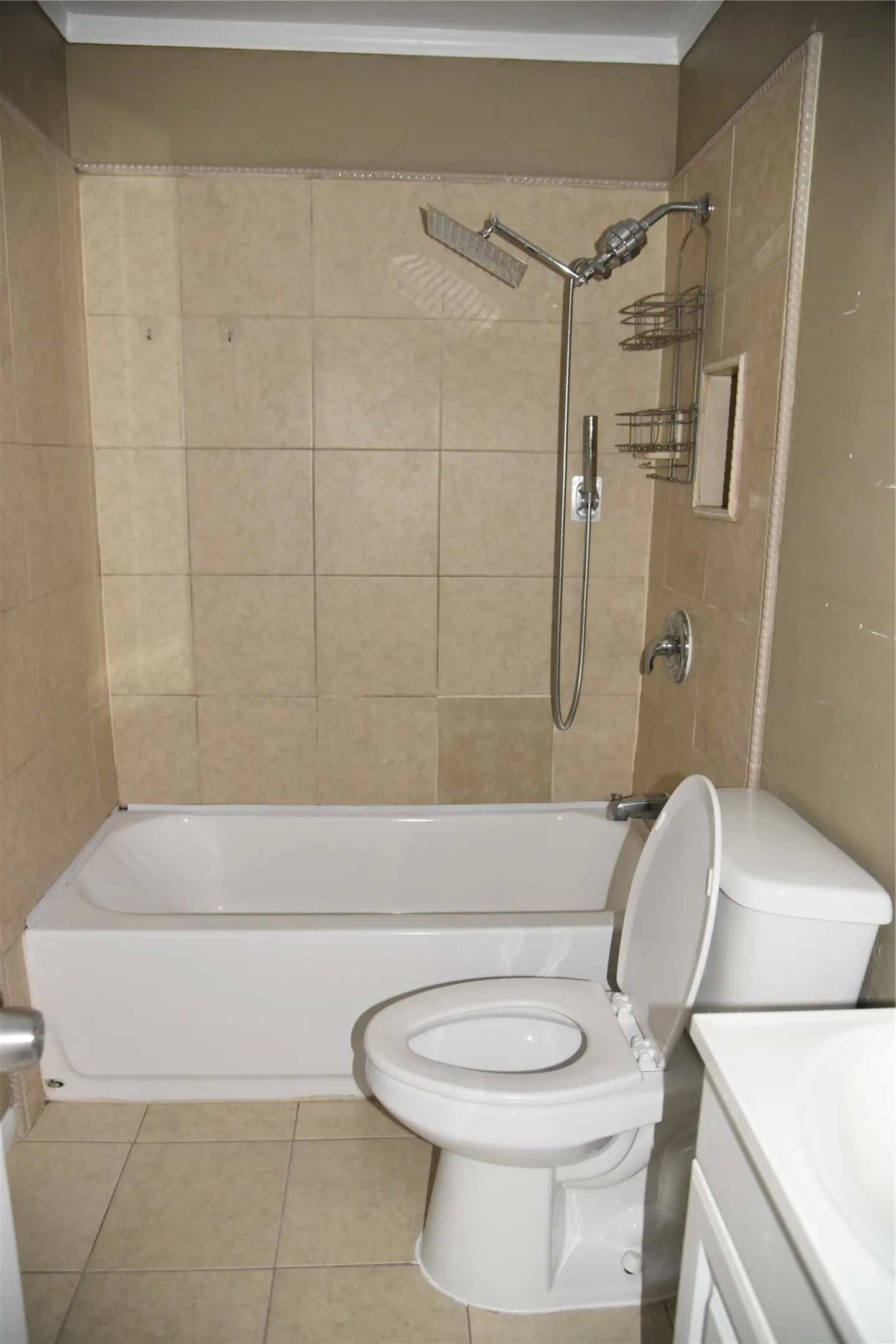 Bathroom featuring a white bathtub, ceramic tile surround, and a chrome shower fixture