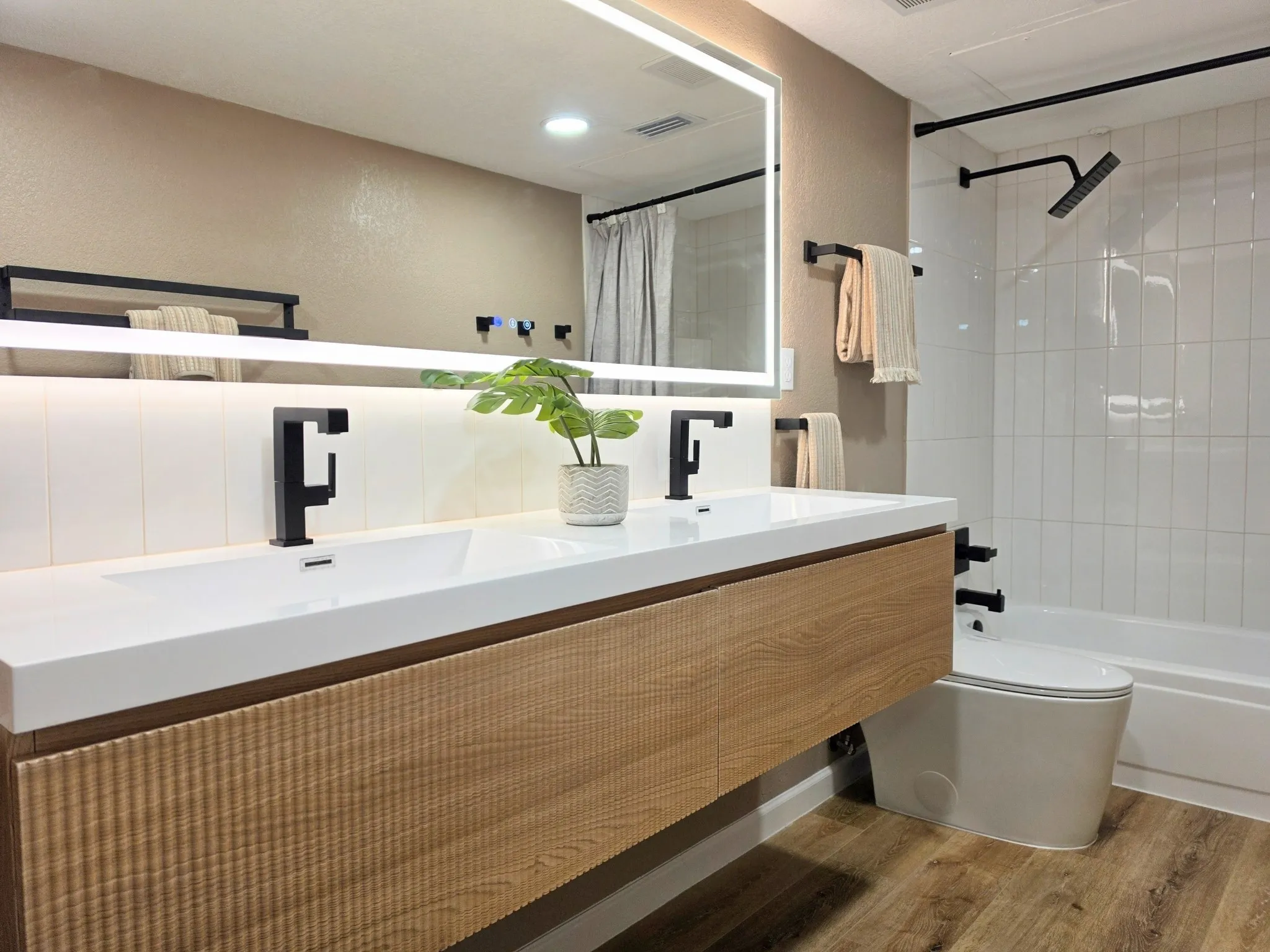 Floating dual vanity with integrated sinks and wood-finish cabinetry