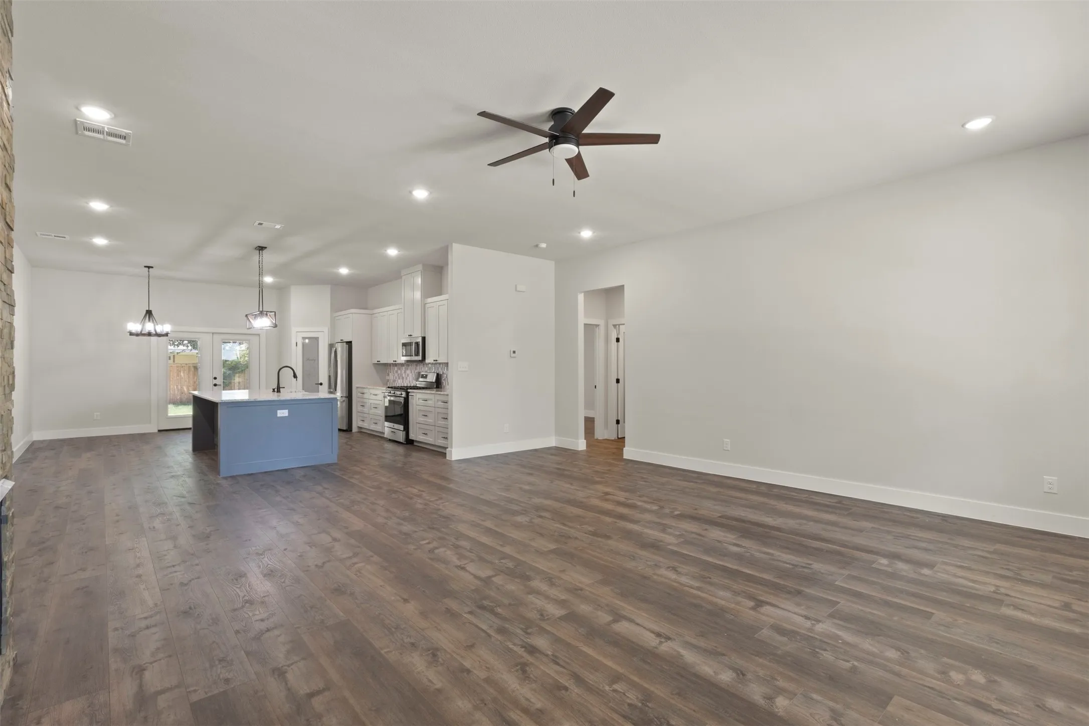 Wood-finish flooring extends throughout this open-concept living space