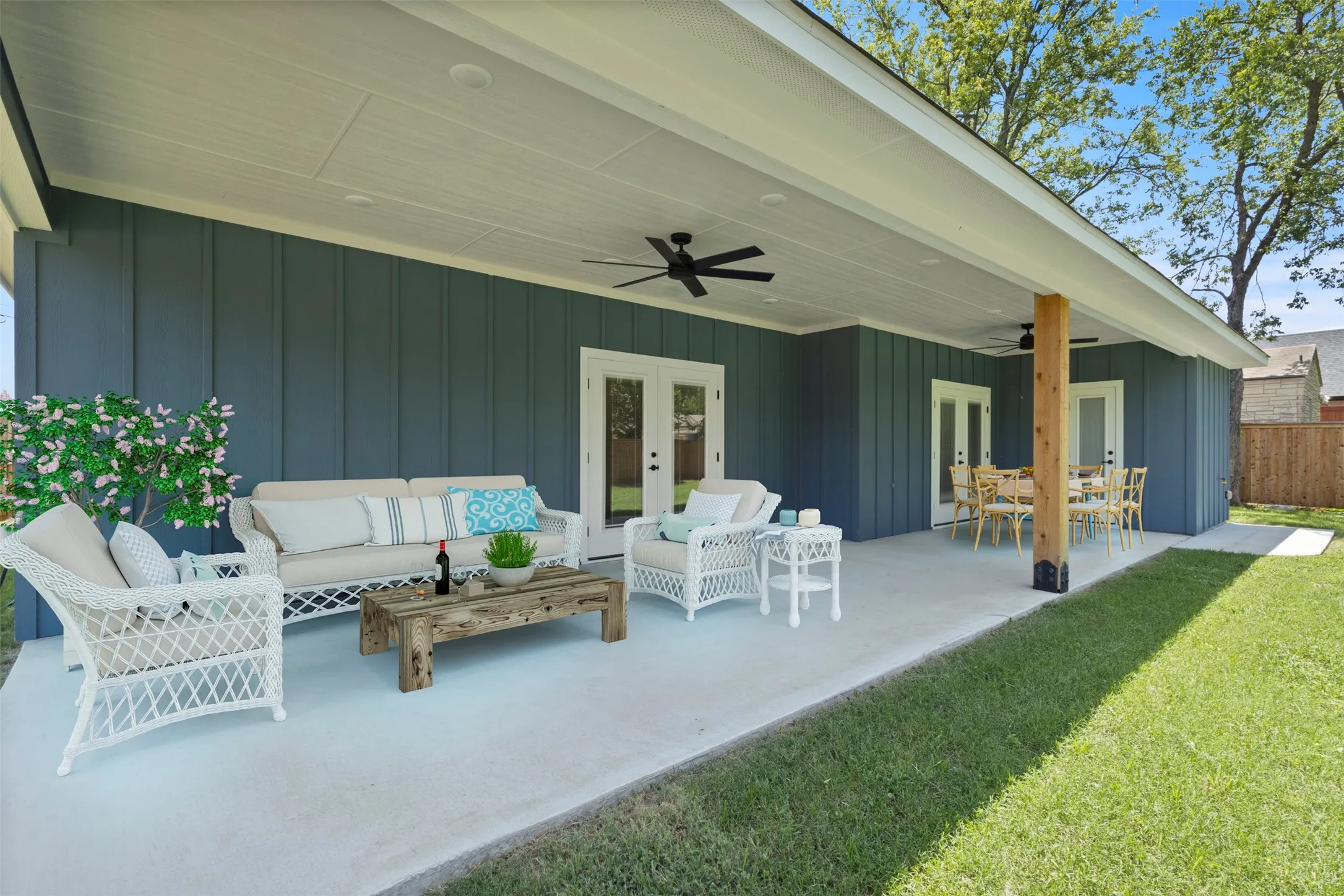 Expansive covered patio featuring a wood-look ceiling fan, recessed lighting, and a prominent wood structural post