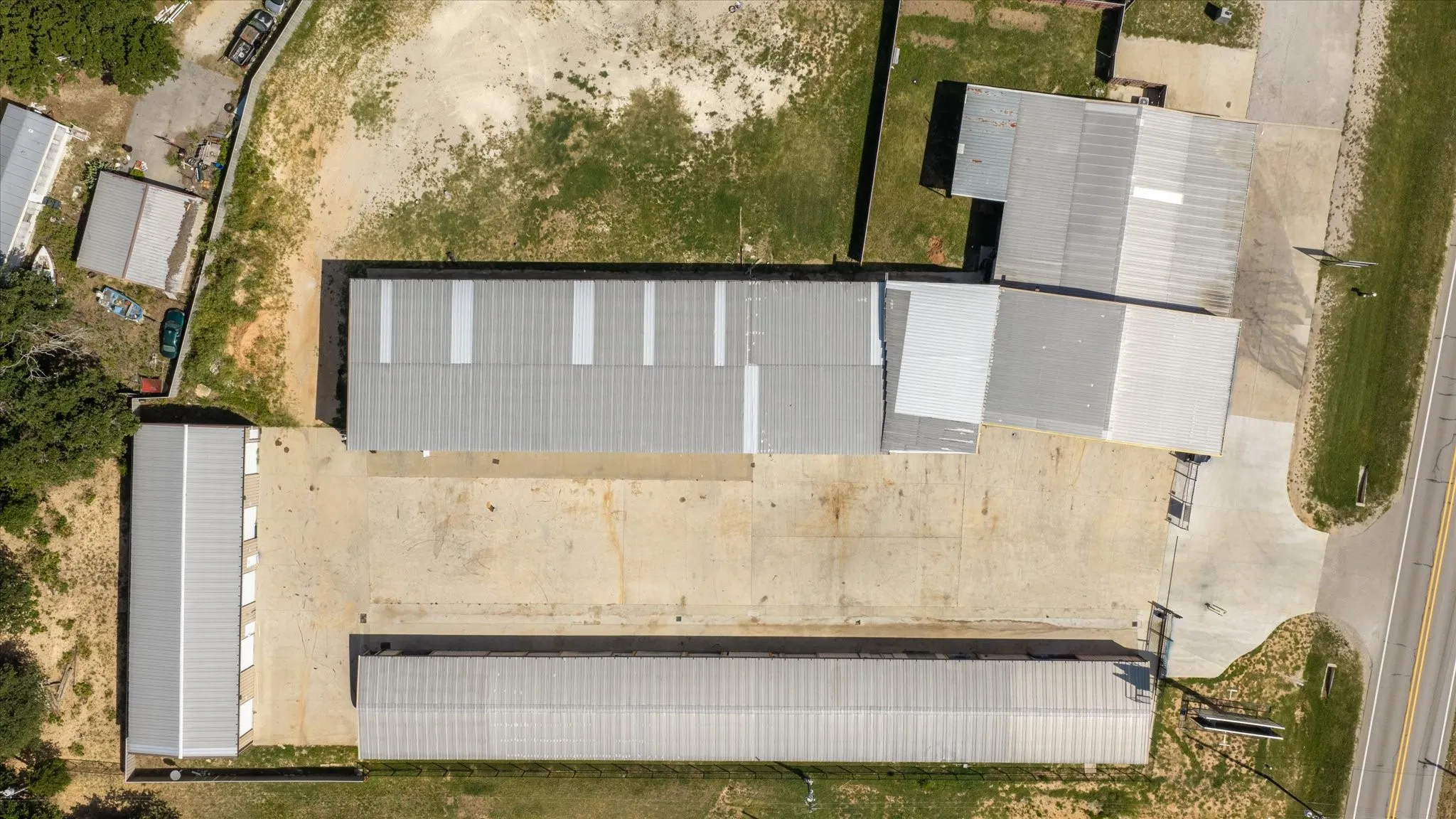 Aerial view showcasing multiple industrial buildings with corrugated metal roofs