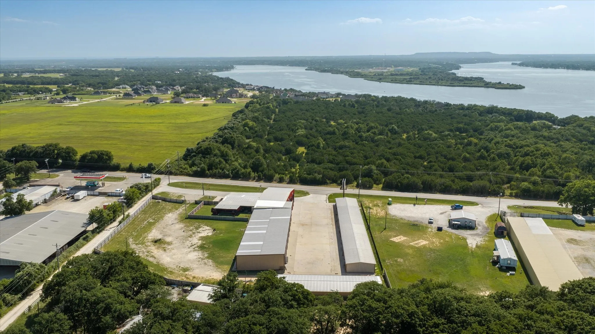 Aerial perspective featuring a clear body of water and expansive green tree cover