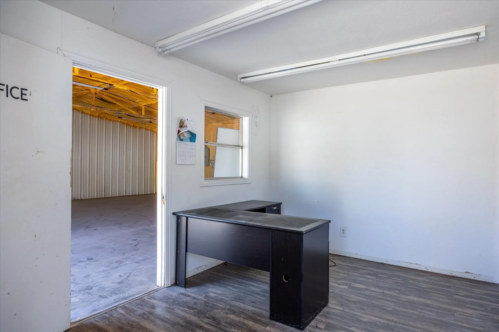 Office space featuring wood-finish flooring and a window