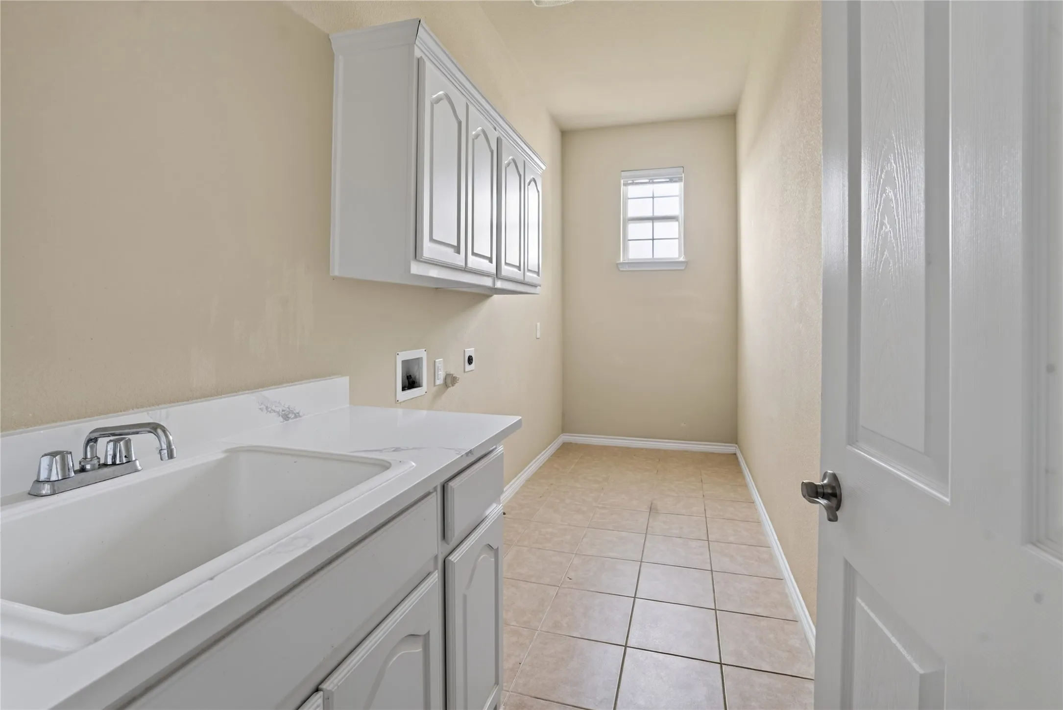 Utility/laundry area has a custom wash basin and cabinatery! Lots of space to have extra fridge or freezer with your washer and dryer.