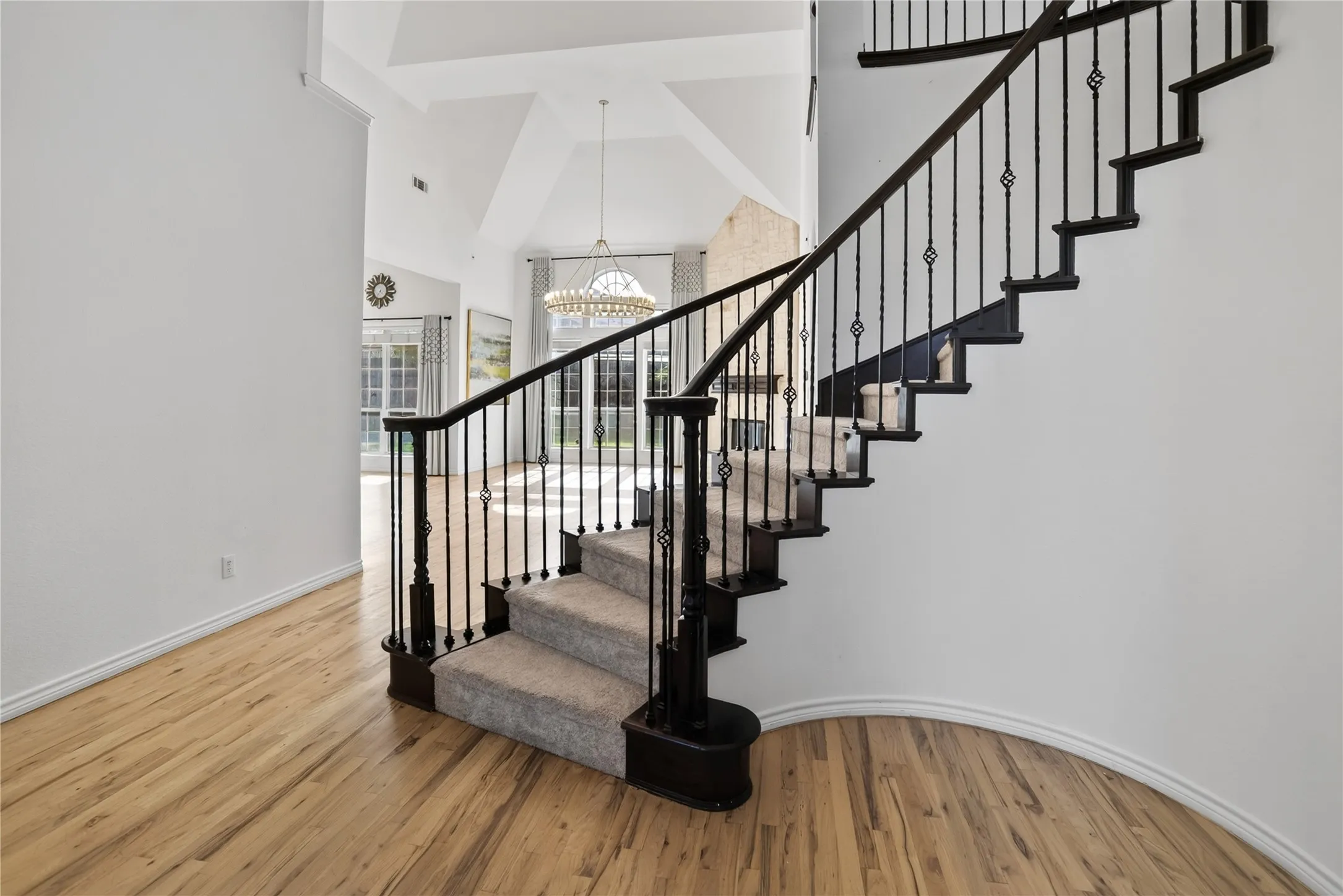 Dramatic stairs by the foyer and elegant high end flooring on main level.