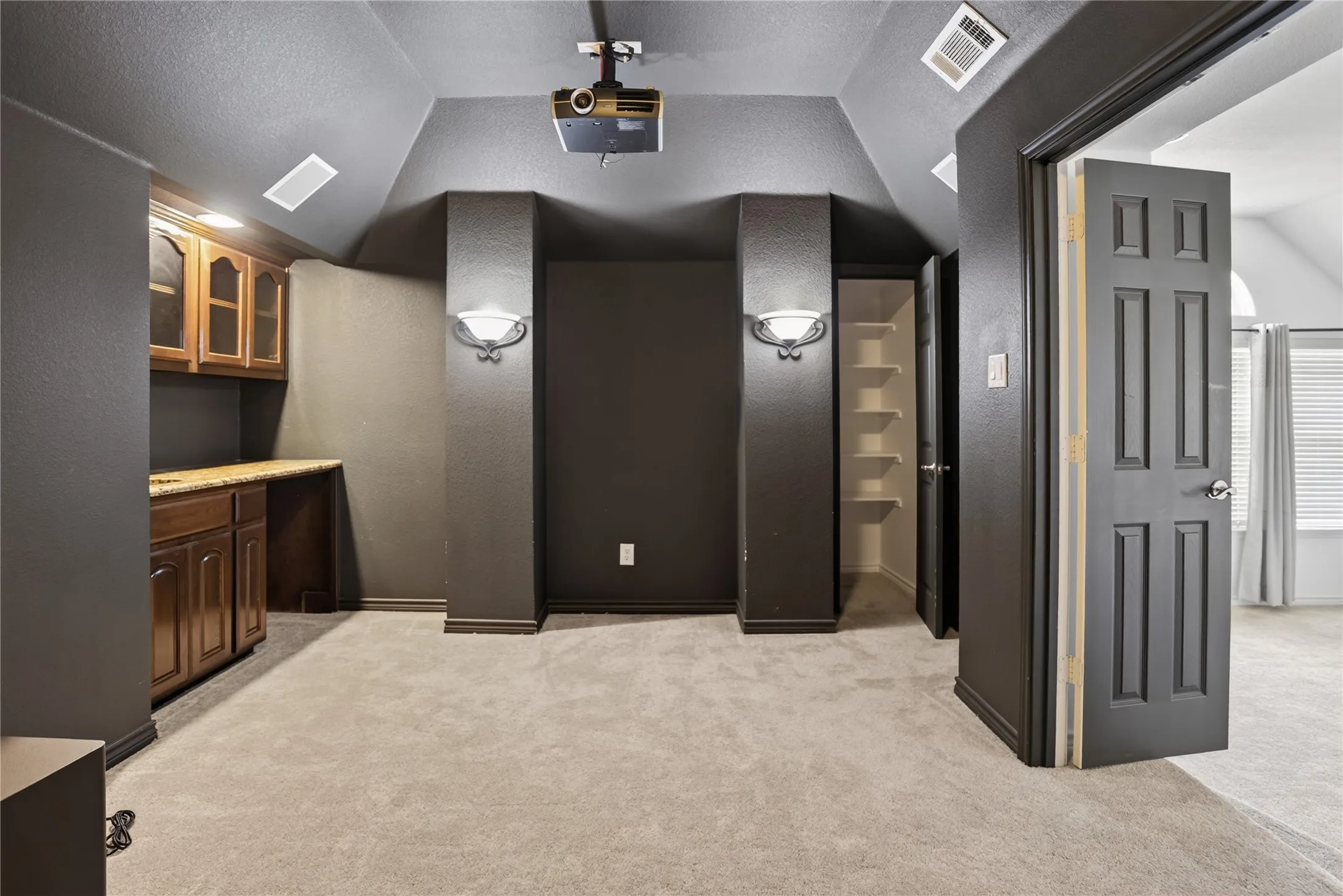 WOW! Media room comes with a custom wet bar feature!