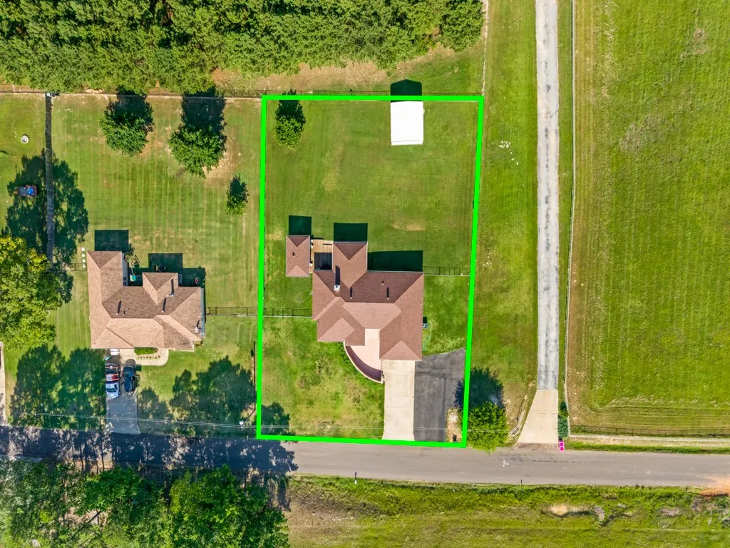 Extensive property featuring a multi-gable roofline, a paved driveway, and a circular entry path