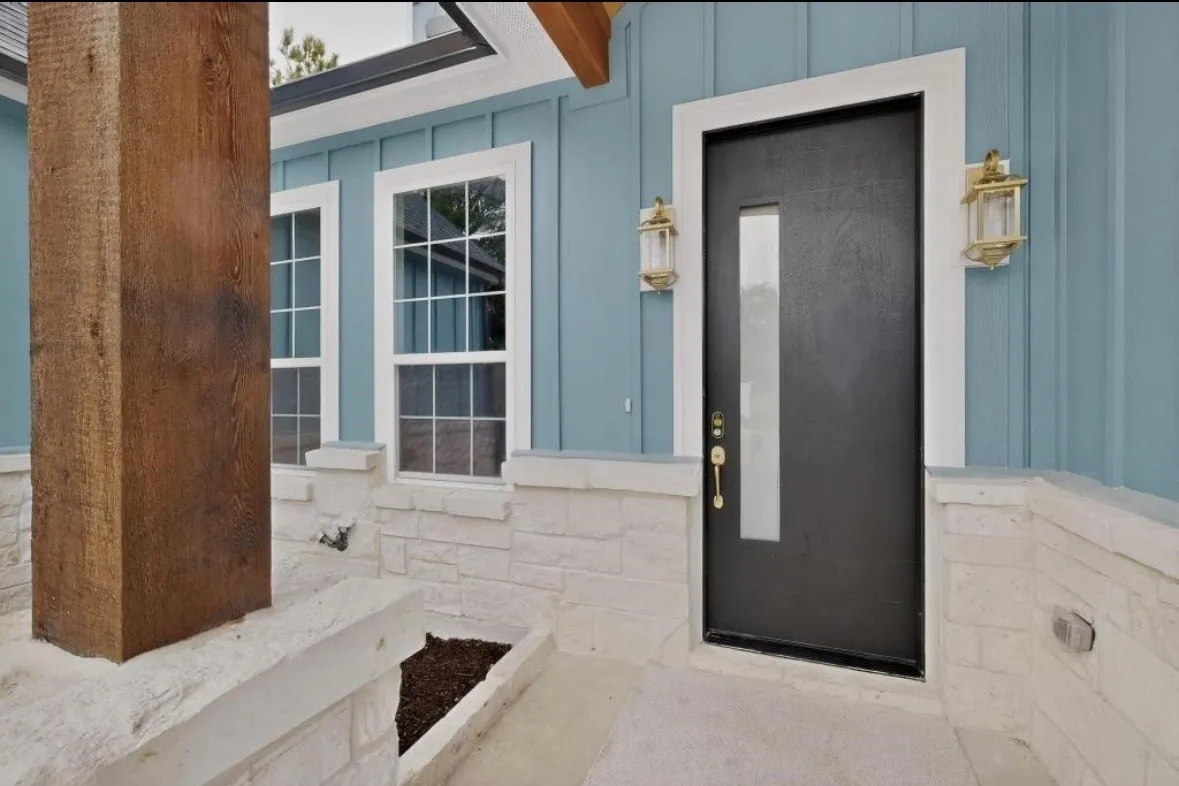 Front entry with a dark door and vertical glass insert