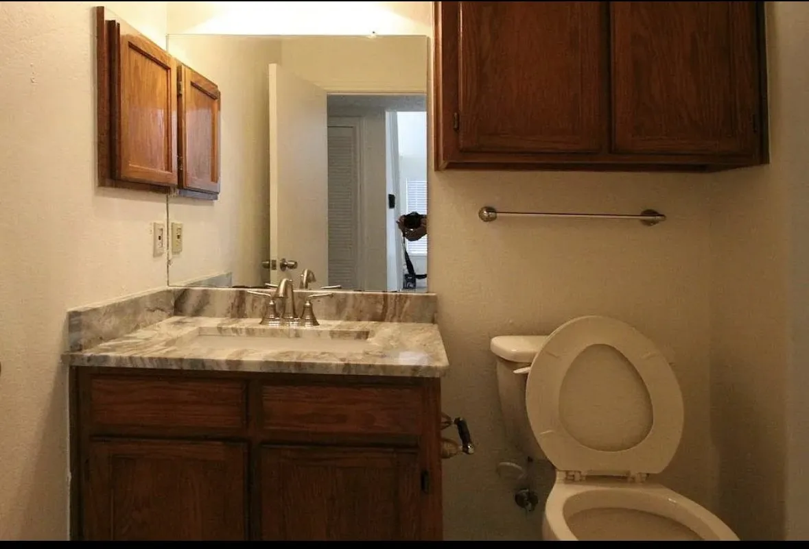 Half bathroom featuring toilet and vanity