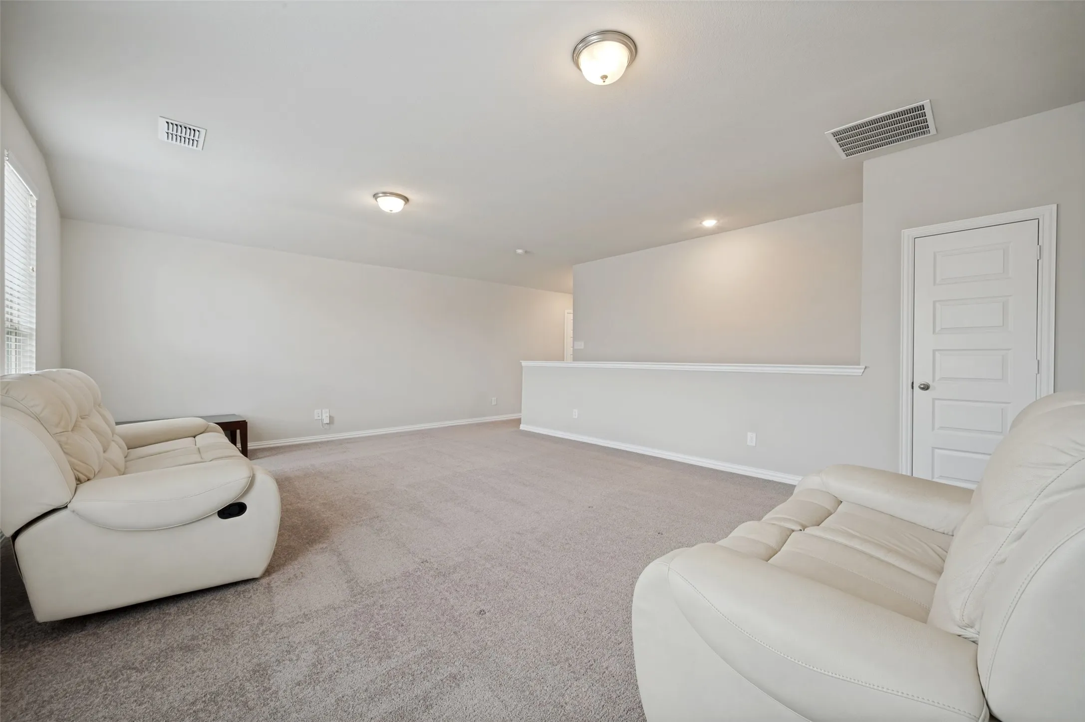 Expansive second-floor game room offering endless possibilities for entertainment, recreation, or a media space. With its generous size and flexible layout, this versatile room is perfect for movie nights, a playroom, home gym, or additional living area