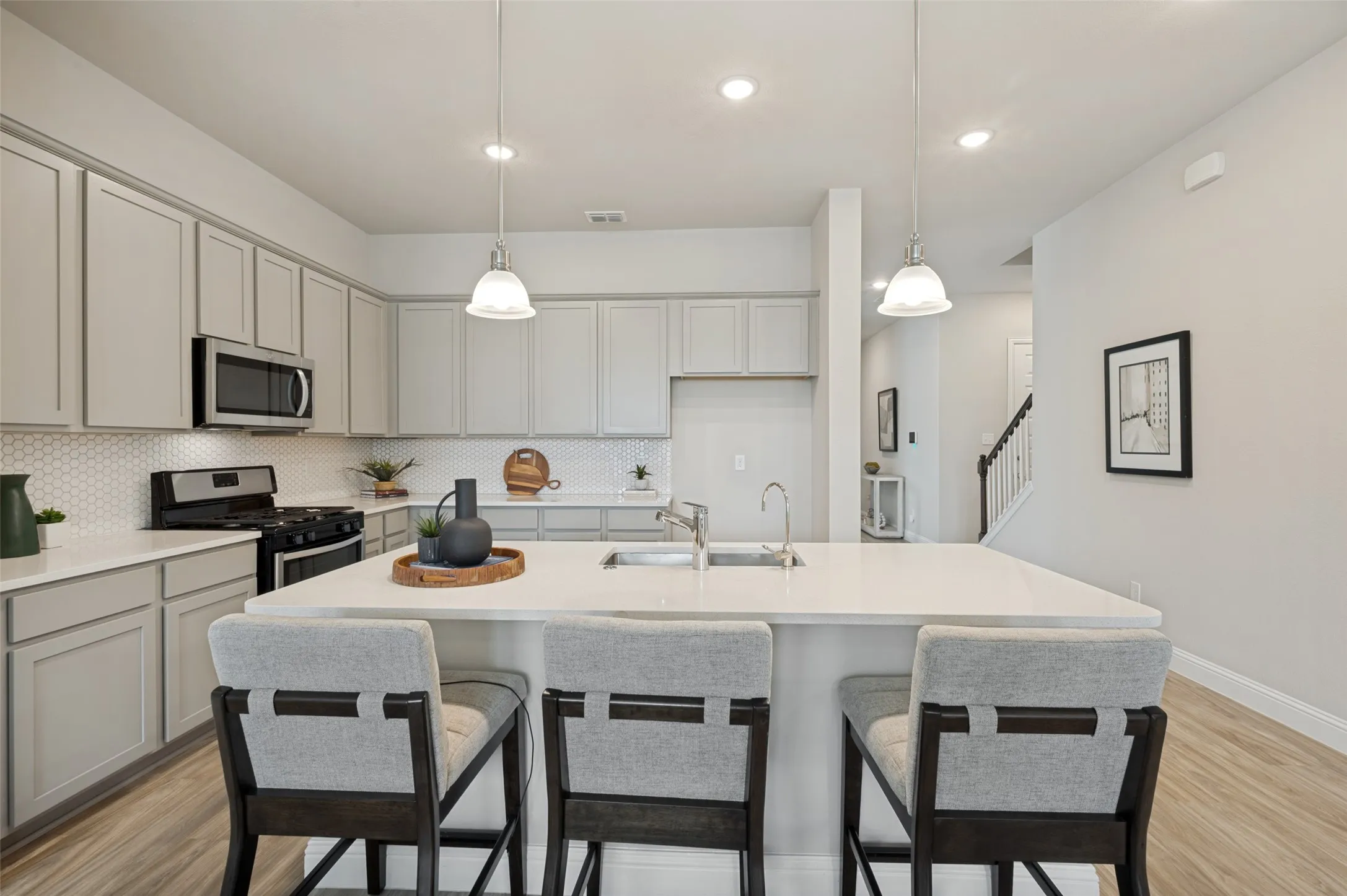 Spacious and inviting family room filled with natural light and designed for comfortable everyday living. The open-concept layout creates a seamless connection to the kitchen and dining areas, making it the perfect space fo