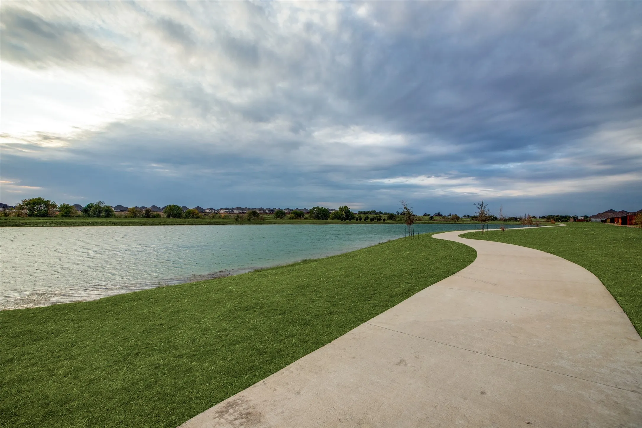 Scenic community walking trail winding along the peaceful neighborhood pond — perfect for morning jogs, evening strolls, or simply taking in the view. A beautiful outdoor feature that adds to the community’s charm and lifestyle appeal.