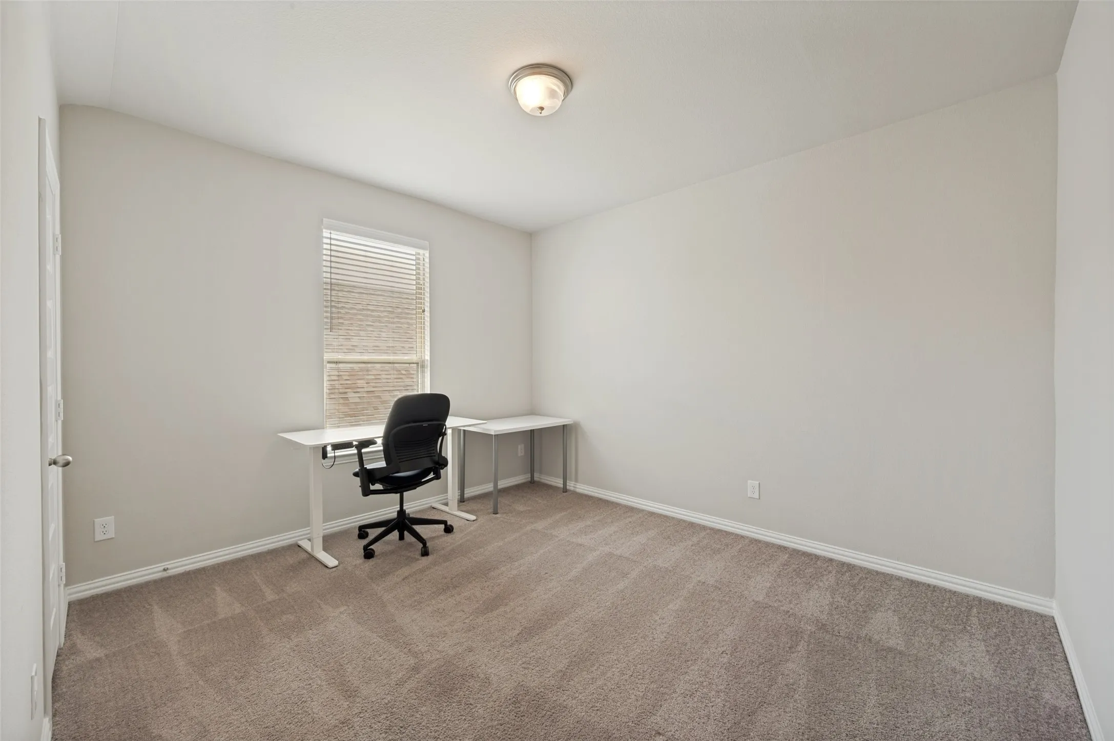 Versatile flex room located on the main level, perfect for a home office, study, playroom, fitness space, or hobby room. Featuring beautiful natural light and a private location, this flexible space easily adapts to your family's needs.