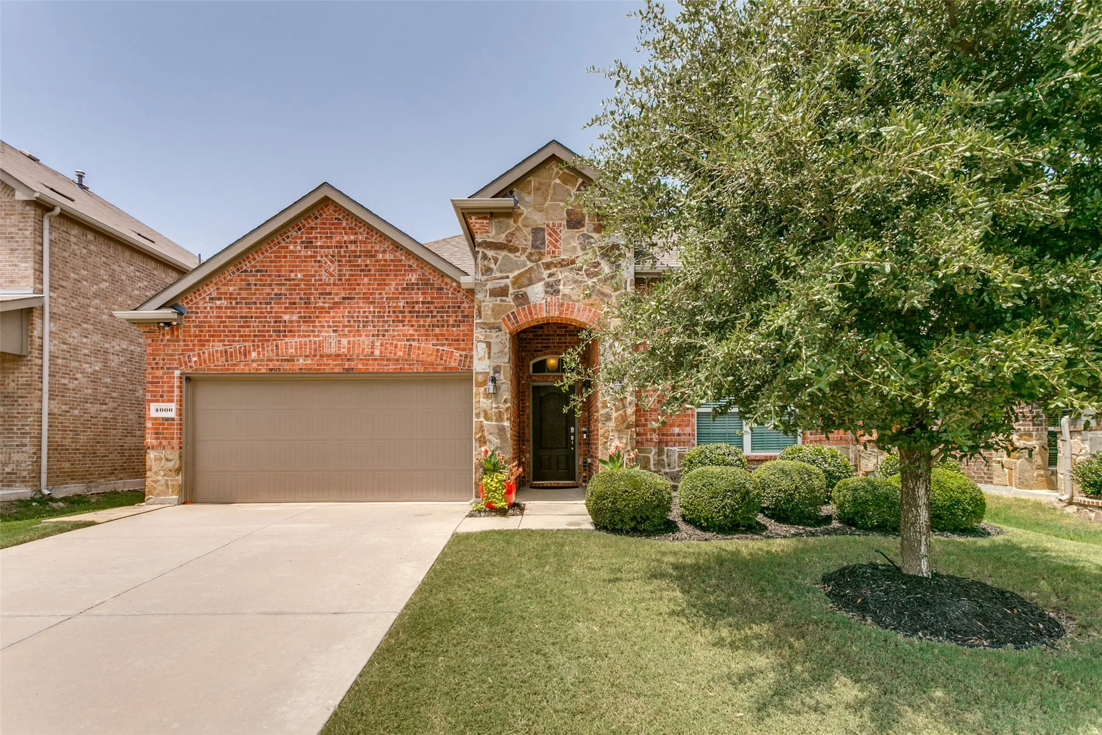 Traditional brick and stone facade with an arched entryway