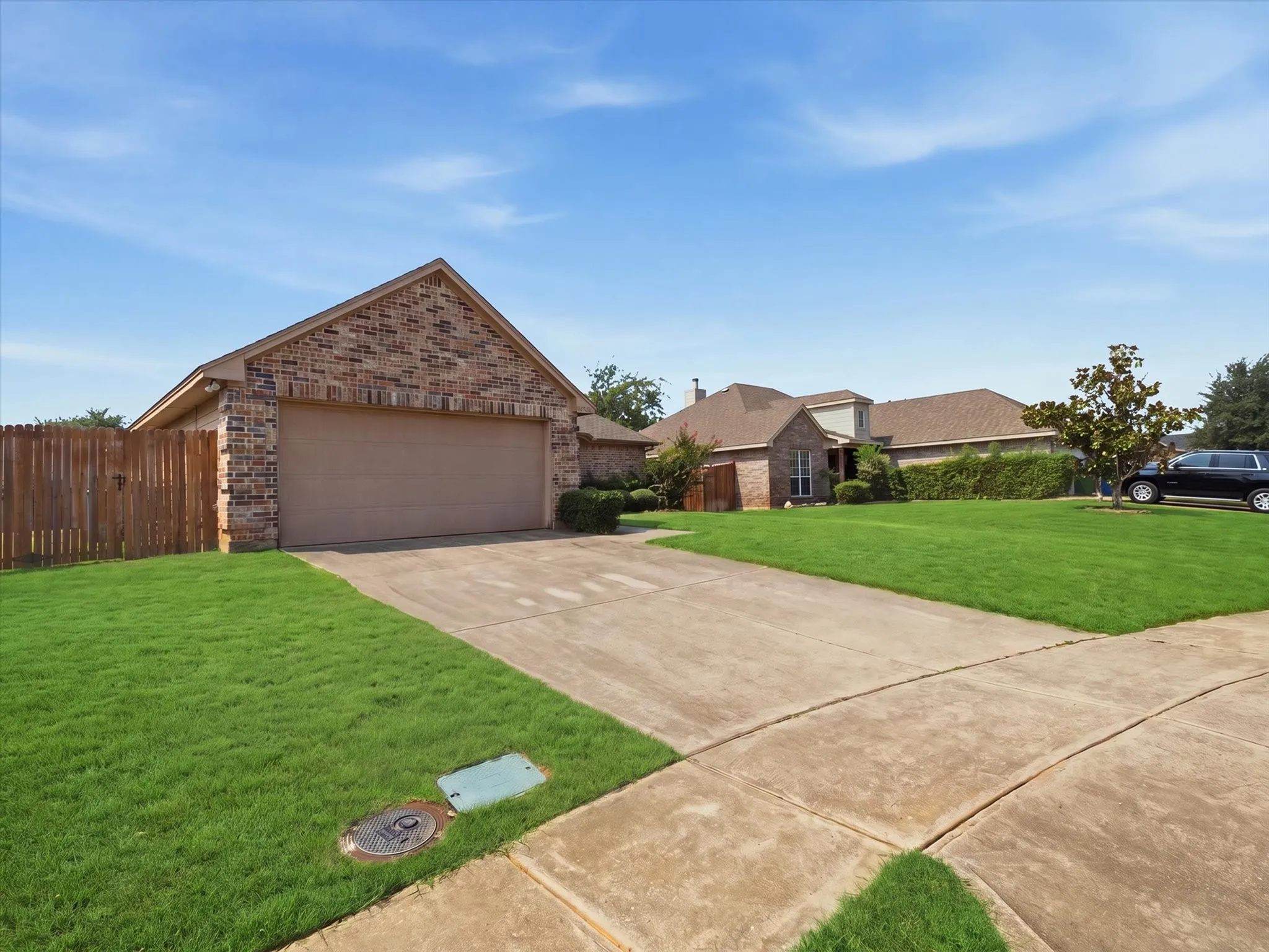 Brick and stone exterior with peaked roofline and two-car attached garage