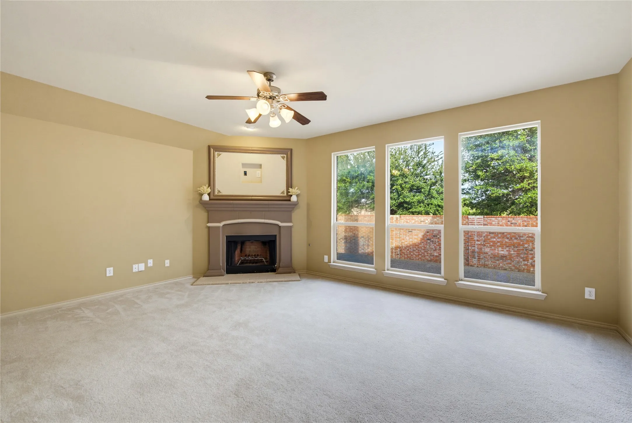 Spacious formal living room with tons of natural light, ceiling fan and fireplace!