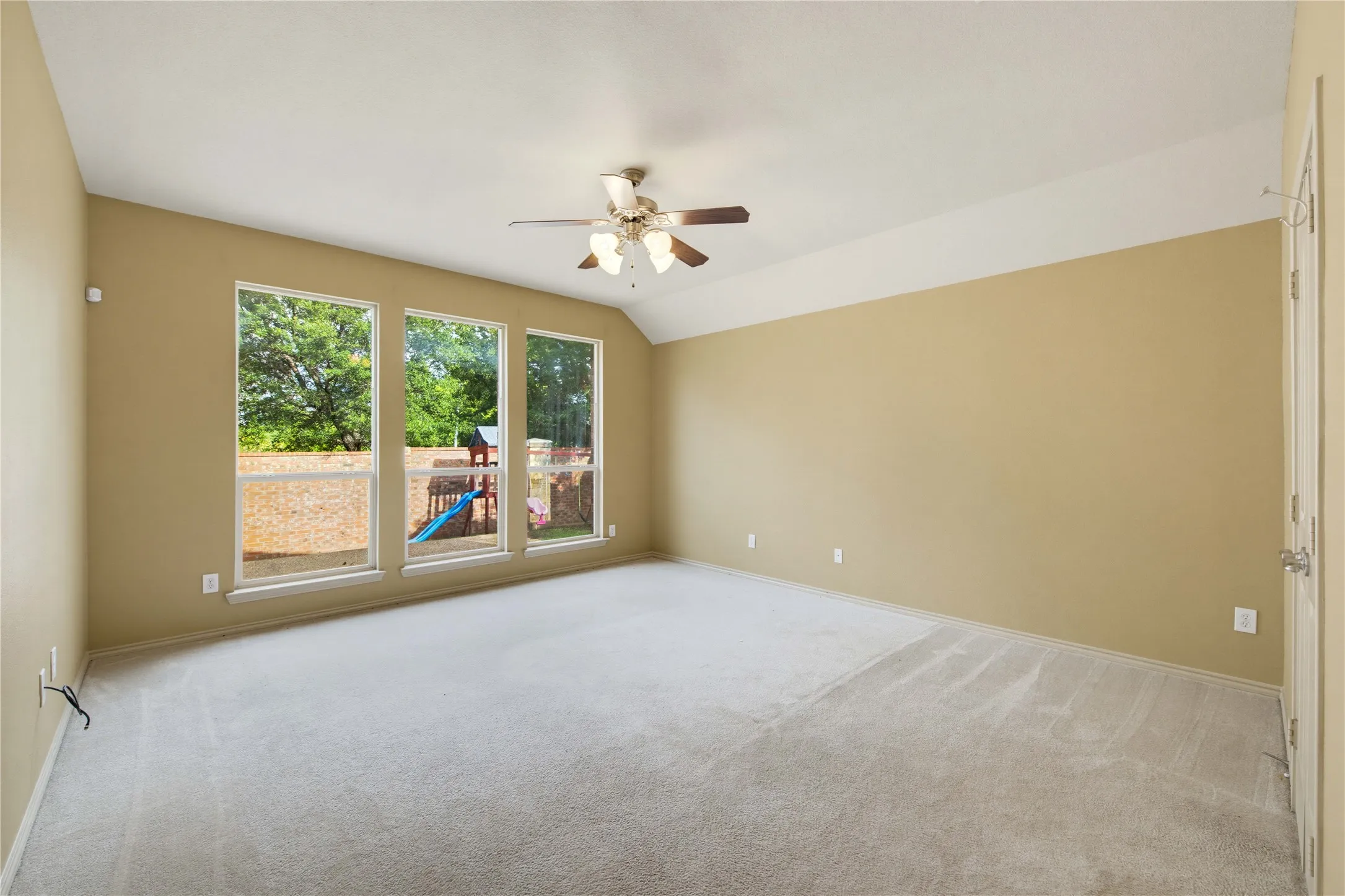 Downstairs primary bedroom with a ceiling fan!
