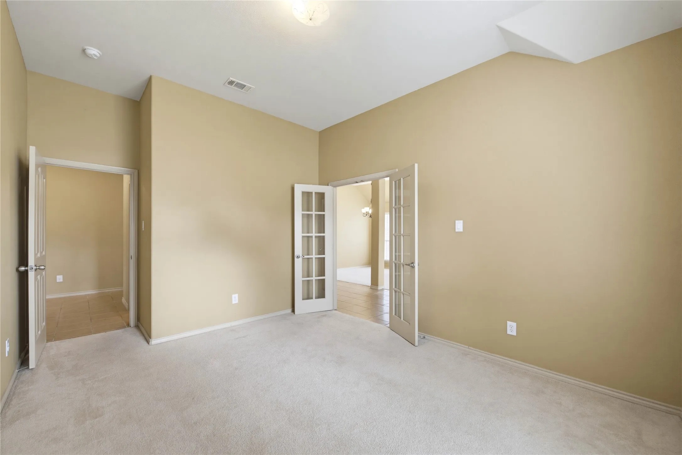 French doors to the office and an additional door leading to the shared bathroom.