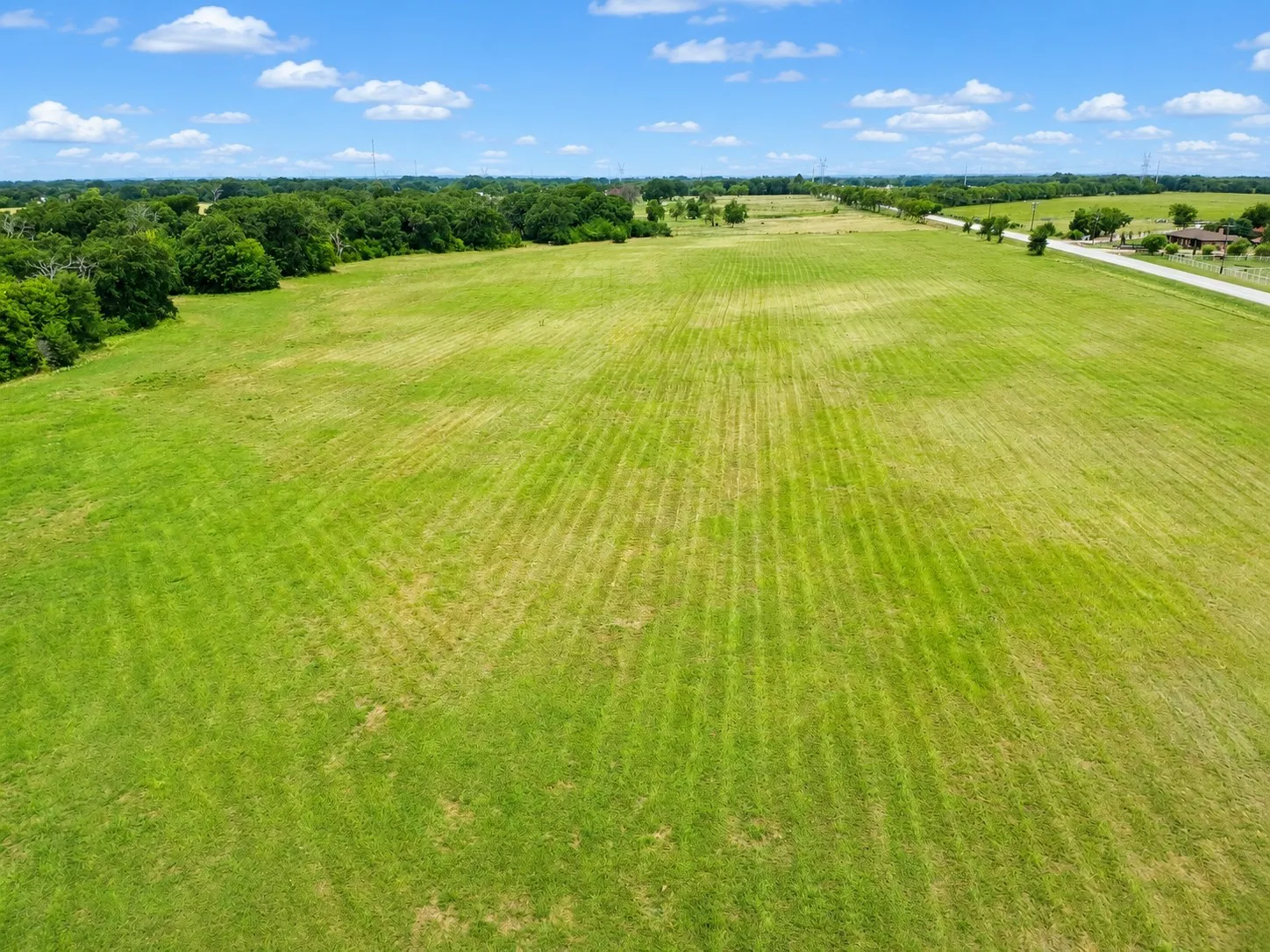 Expansive green acreage with a neatly maintained lawn