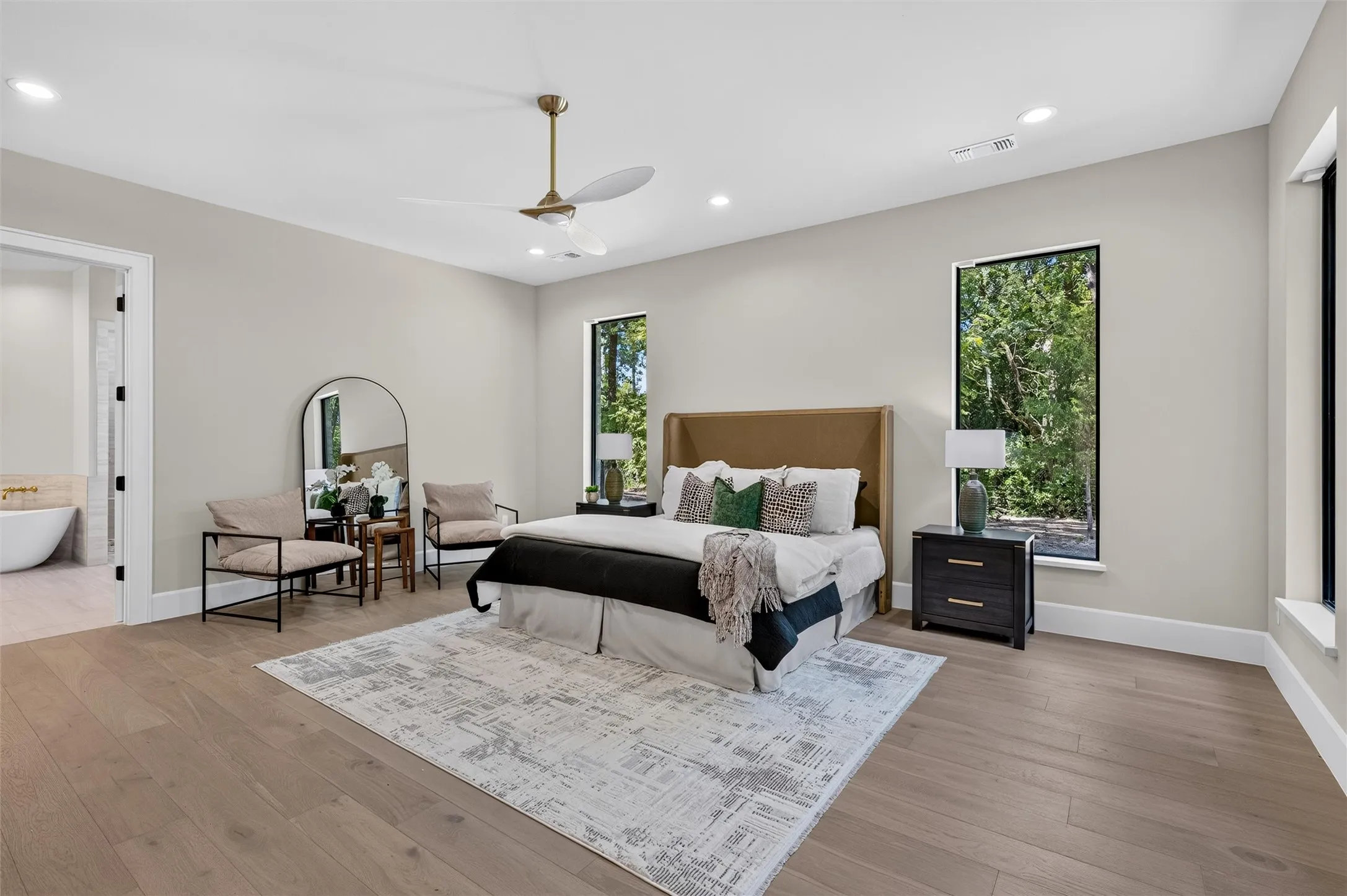 Primary bedroom with natural lighting and beautiful outdoor views.