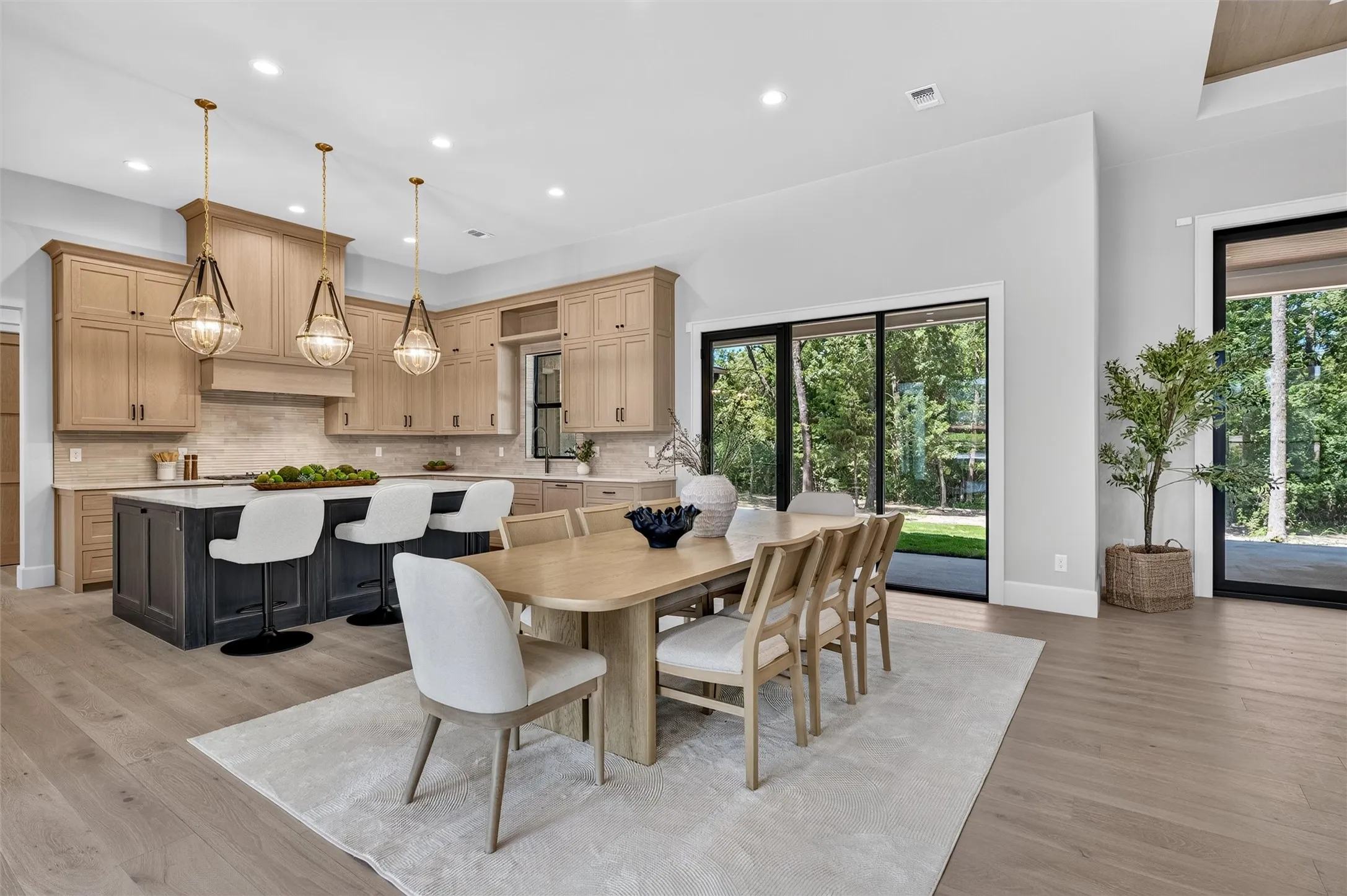 Open dining area with beautiful views of back yard foliage.