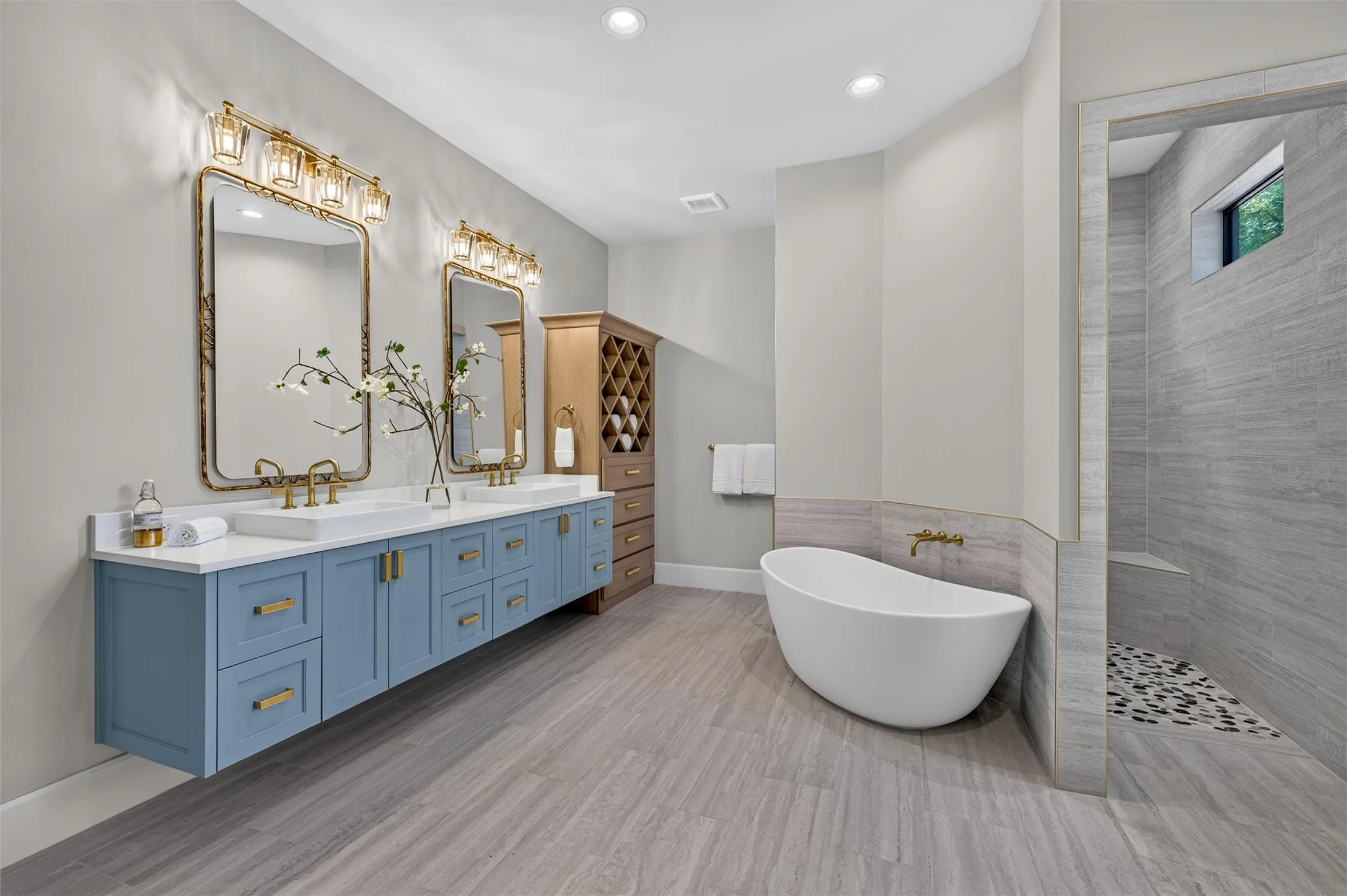 Ensuite primary bath feature floating vanity with custom paint and soaking tub.