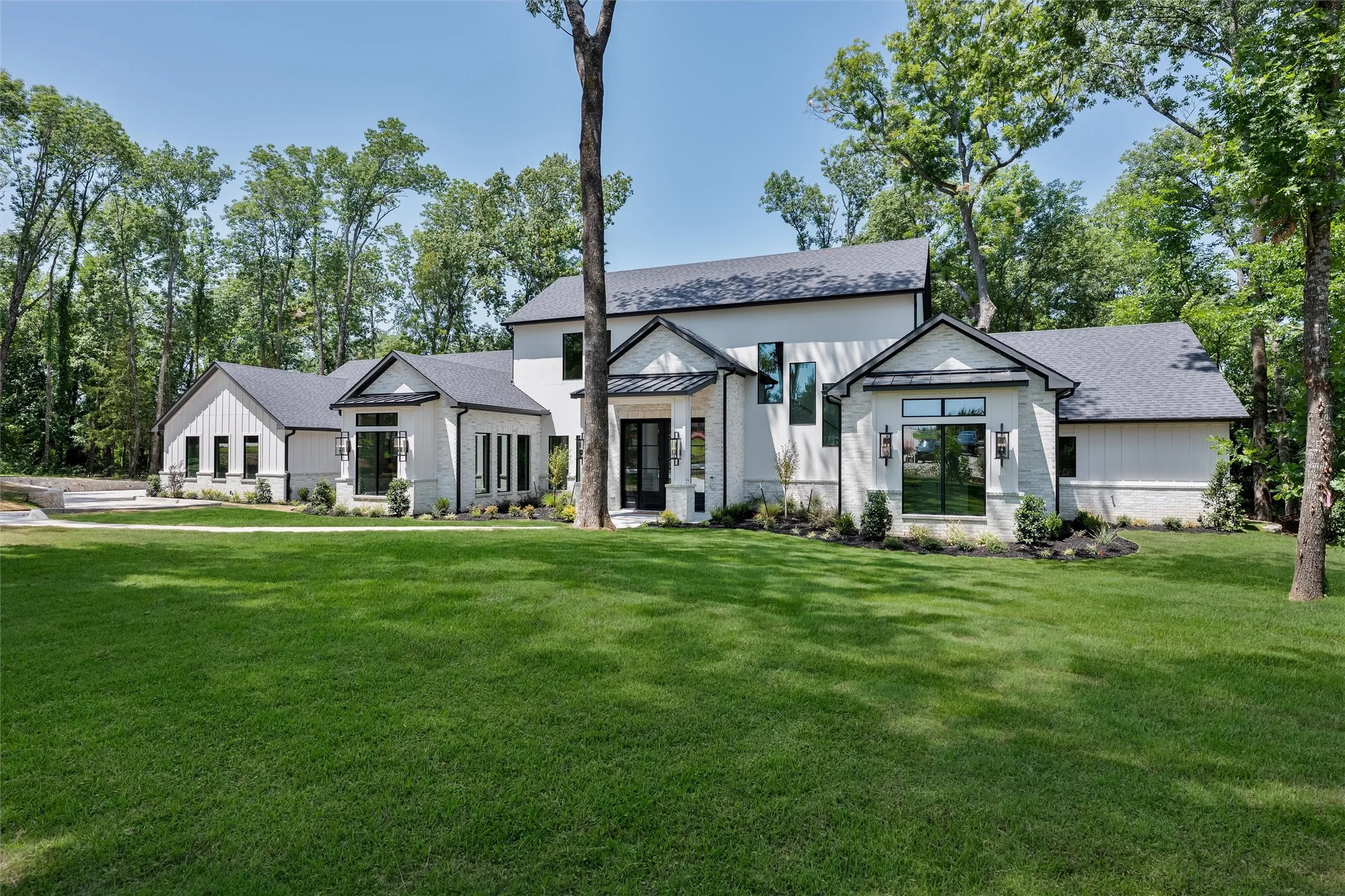 Landscaped beds and wooded lot provide a gorgeous entry.