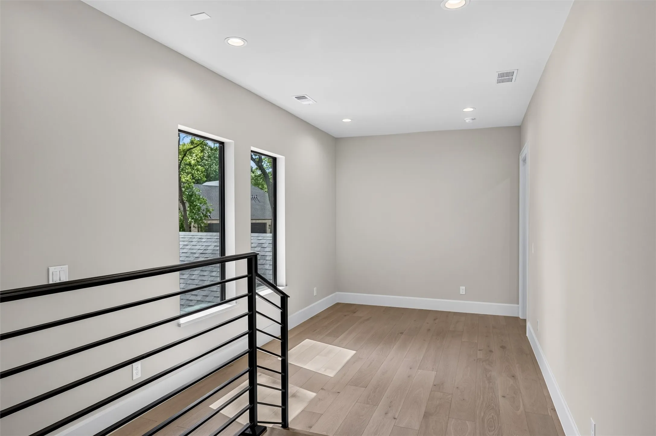 White oak hardwood flooring continues to the second floor landing.