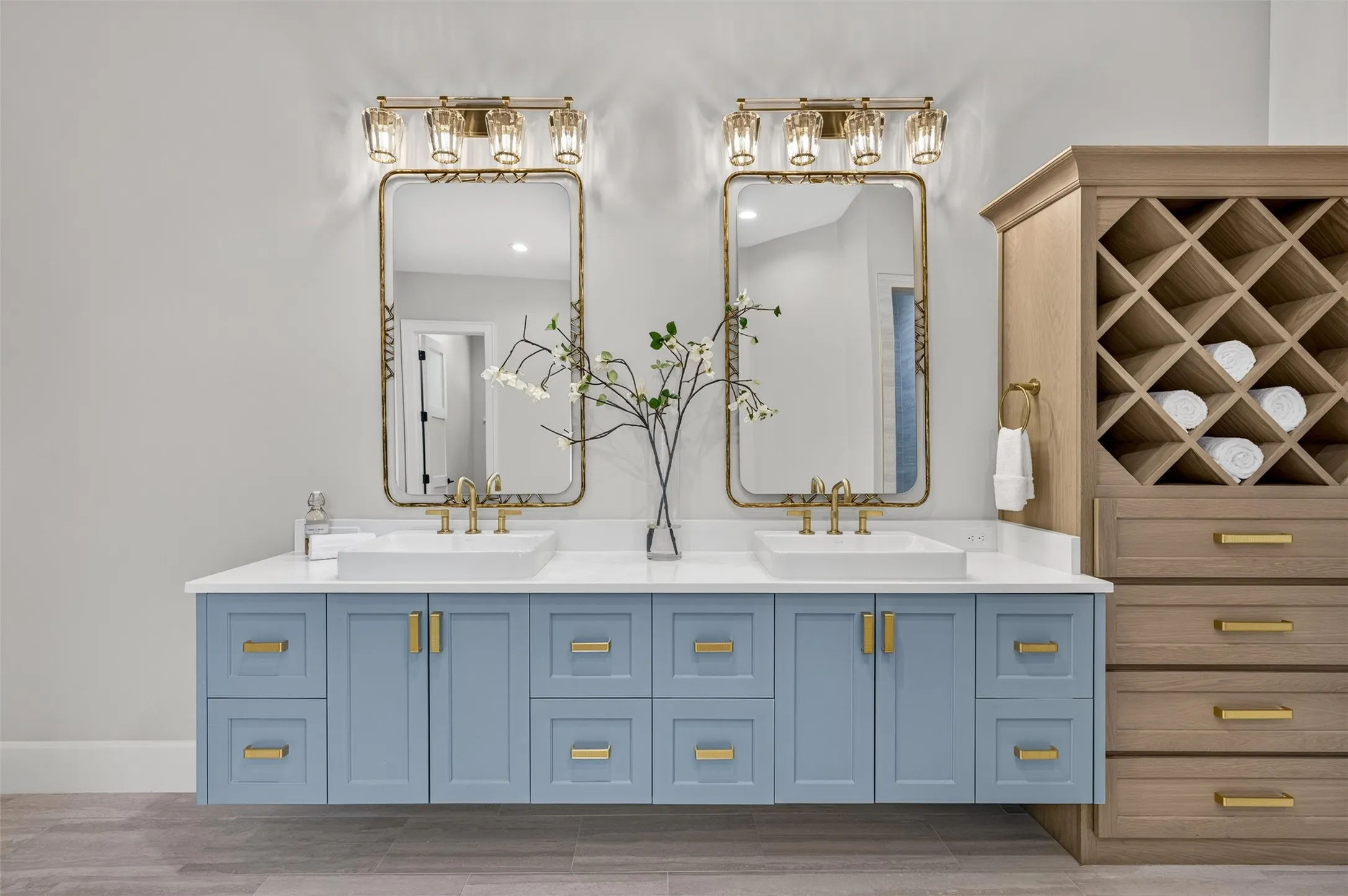 Stunning double vanity and built in cabinet in primary bathroom.