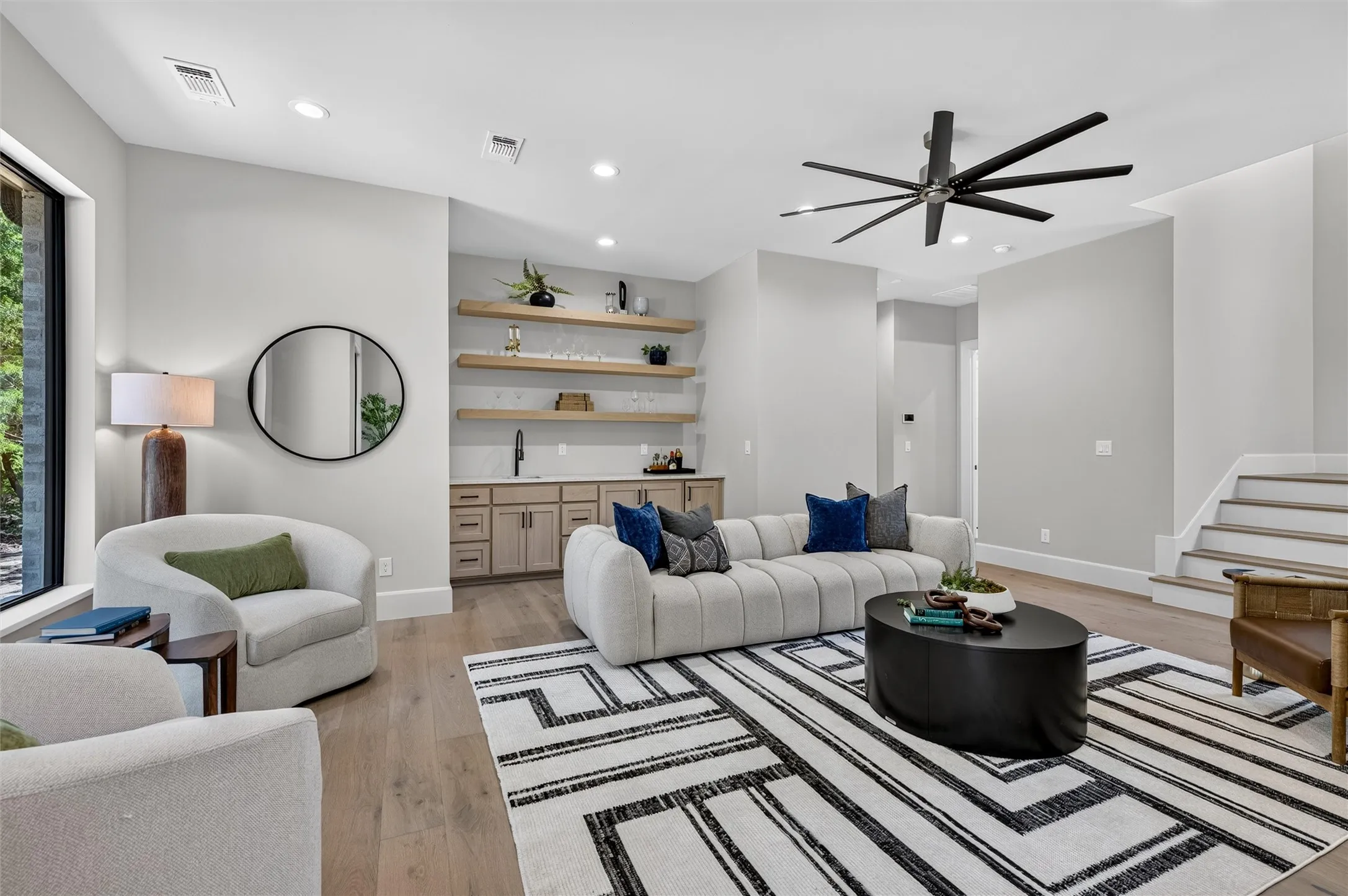 Family room with built in shelving and wet bar.