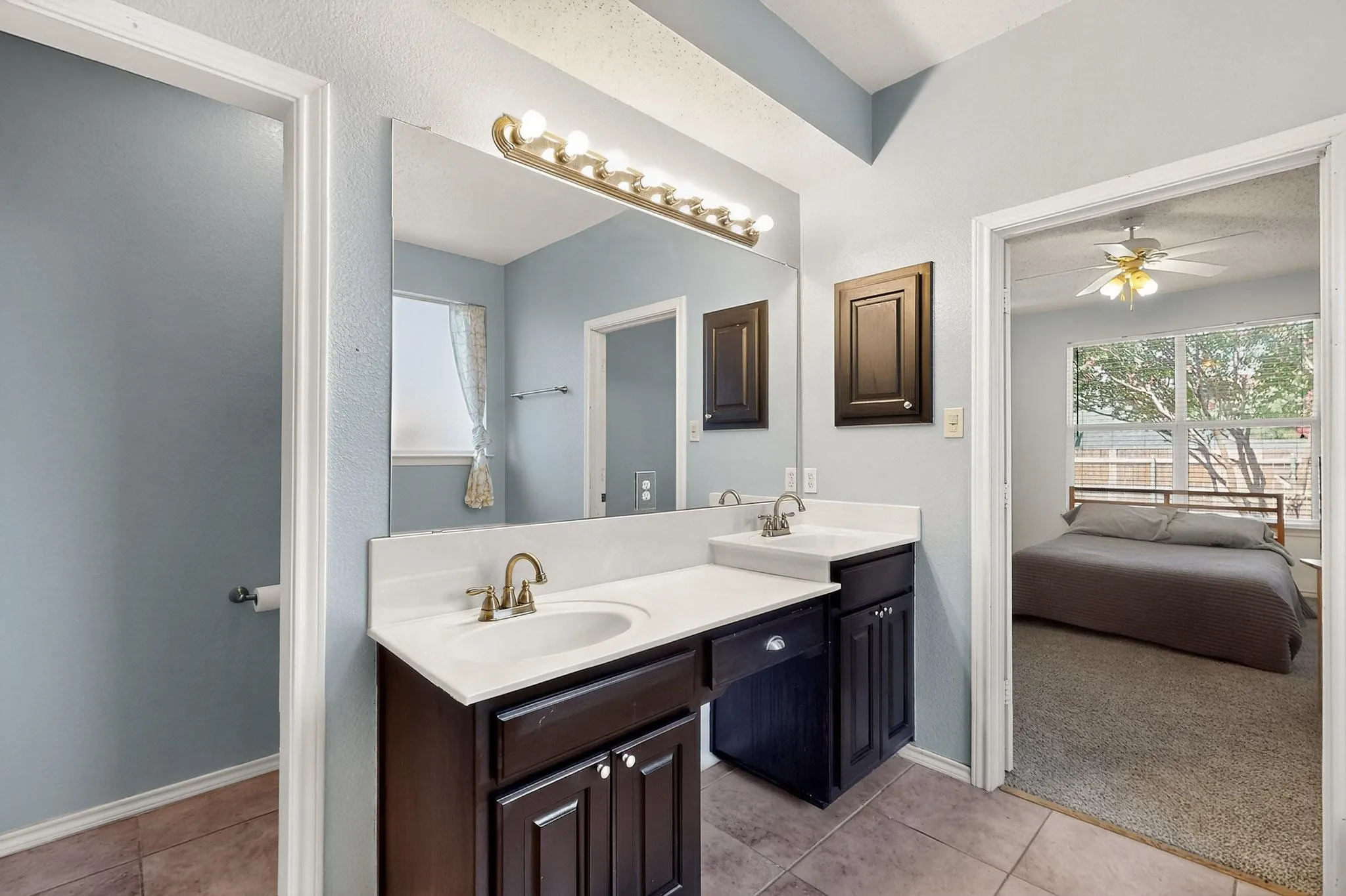 Bathroom featuring double vanity, tile patterned flooring, ensuite bath, and ceiling fan