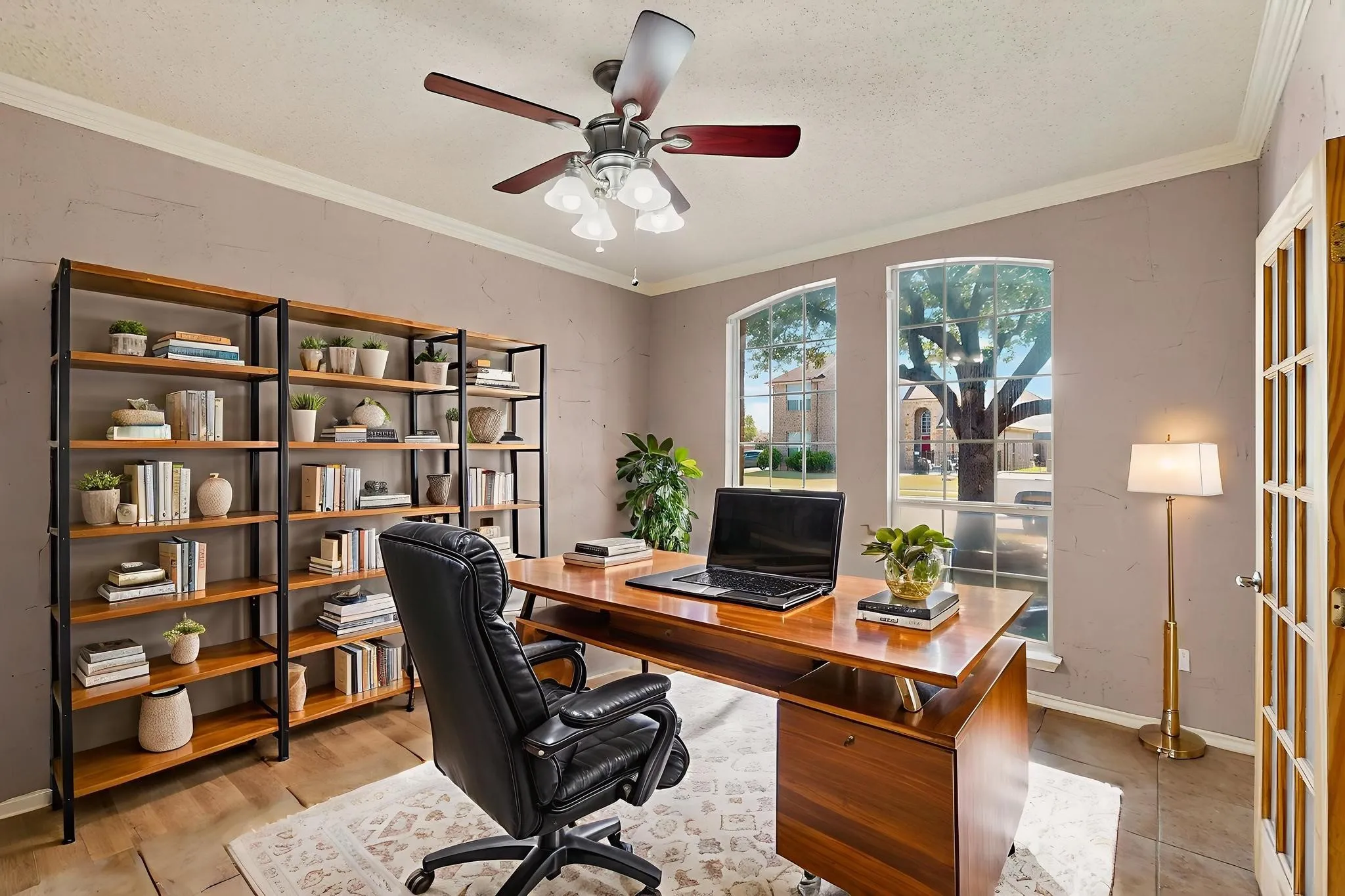 Office area featuring a ceiling fan, ornamental molding, and light wood-type flooring  *Virtually staged