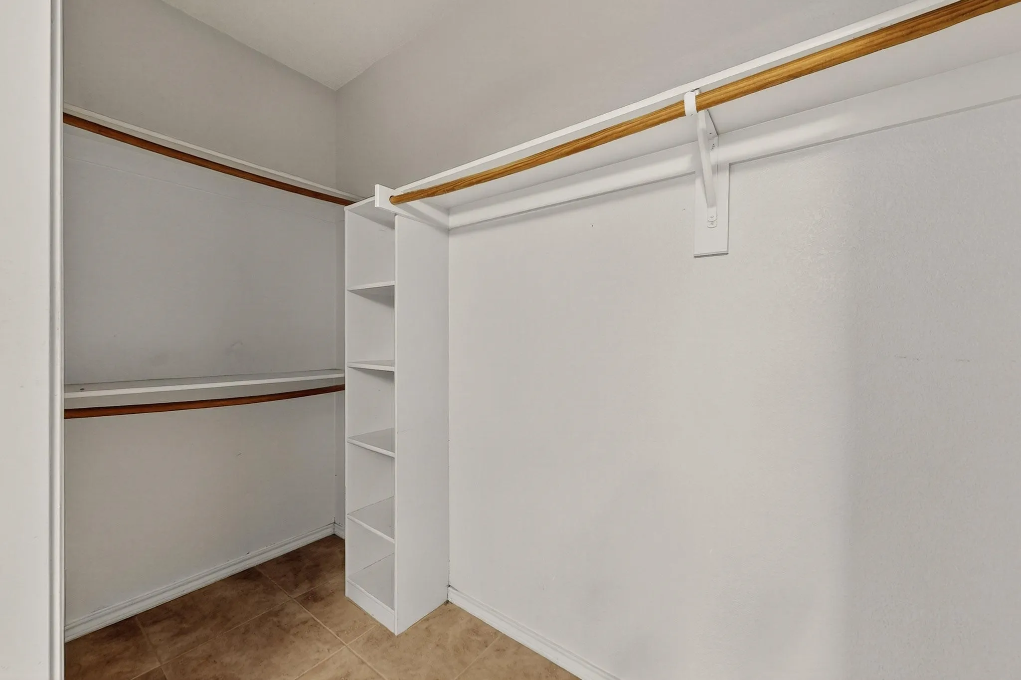 Walk in closet featuring tile patterned flooring