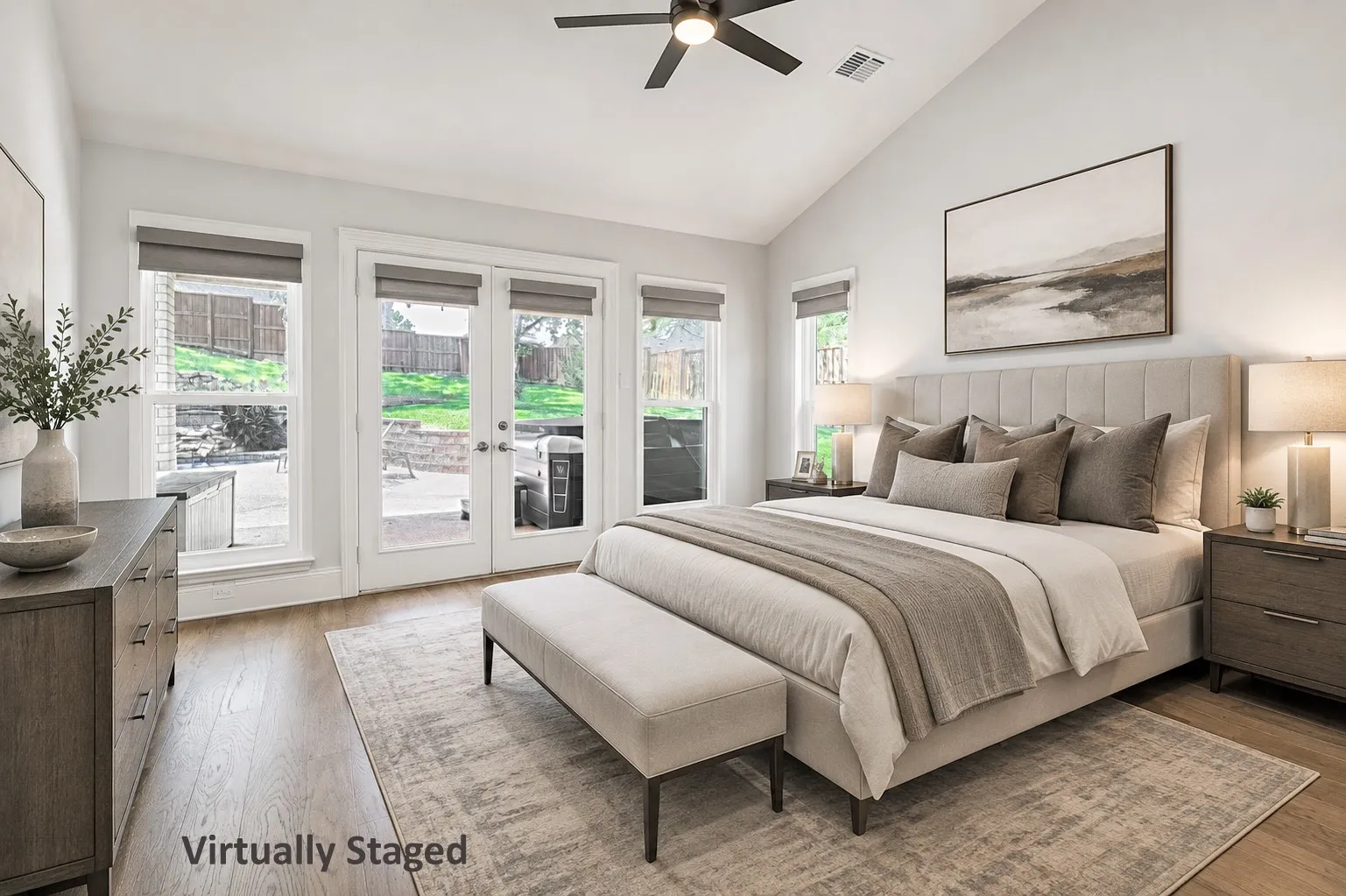 Virtually Staged: Vaulted ceiling bedroom with wood-finish flooring, featuring a ceiling fan and recessed lighting