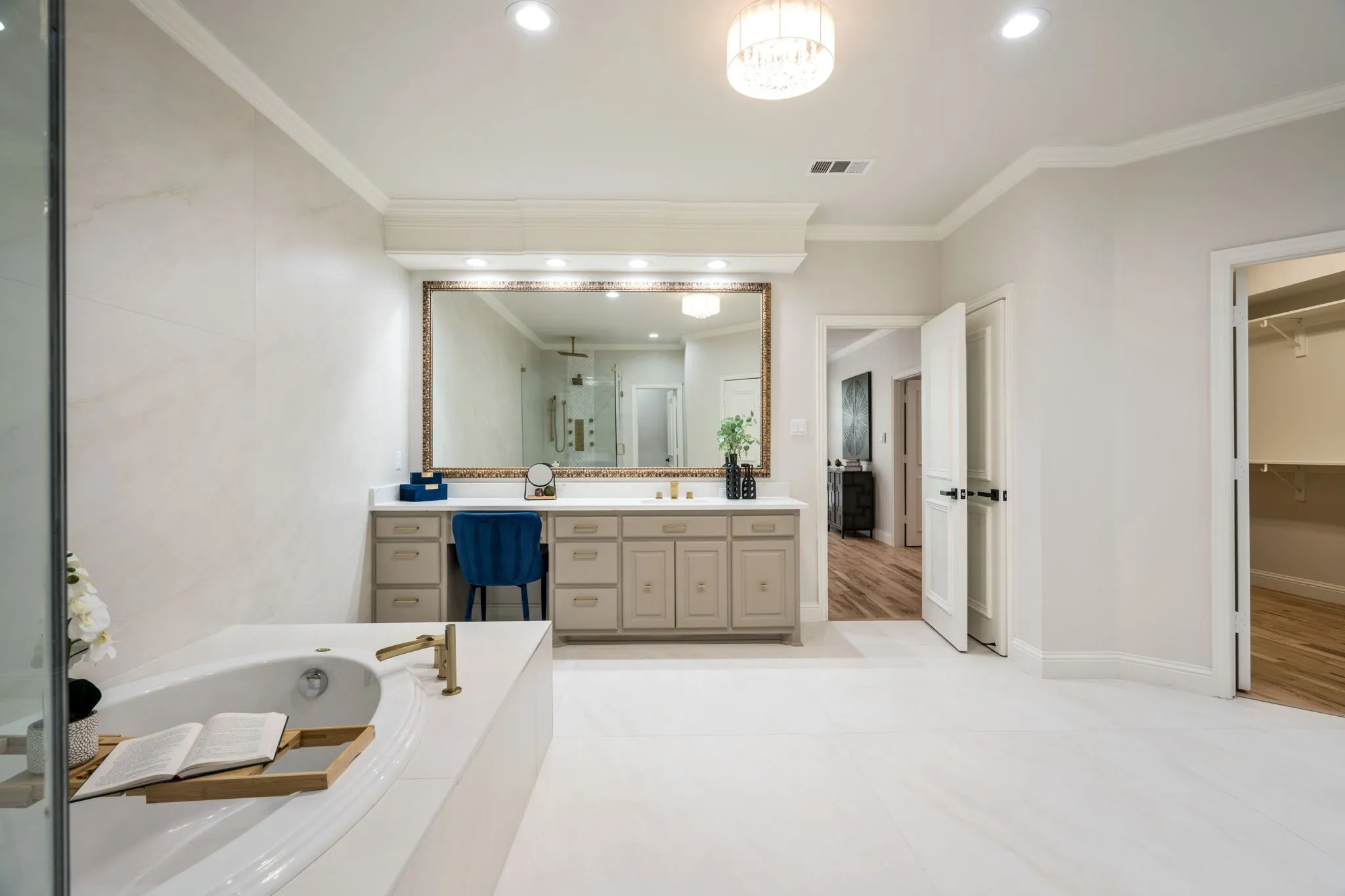 Bathroom featuring ornamental molding, vanity, a spacious closet, recessed lighting, and a garden tub