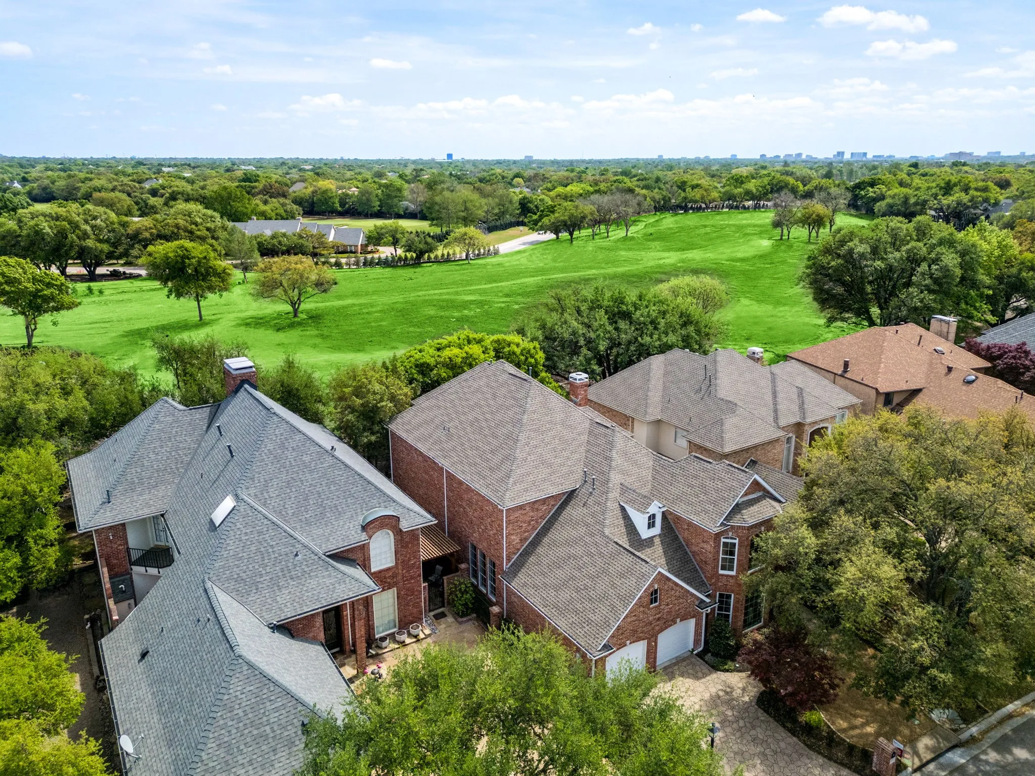 Bird's eye view of a golf club and a tree filled landscape