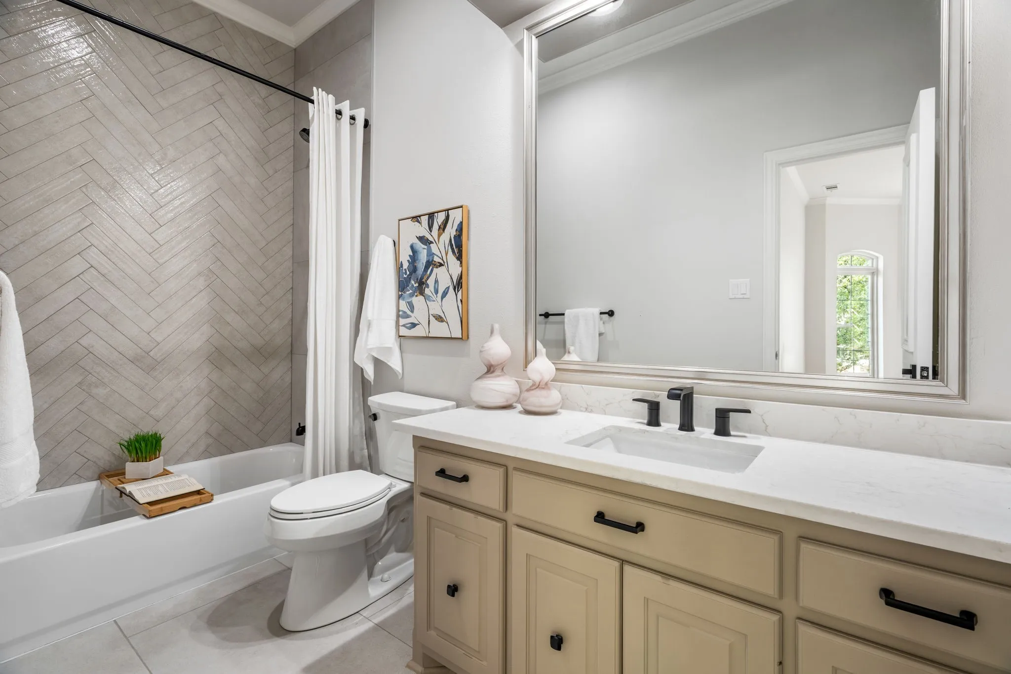 Bathroom featuring crown molding, vanity, shower / bath combo with shower curtain, and light tile patterned flooring