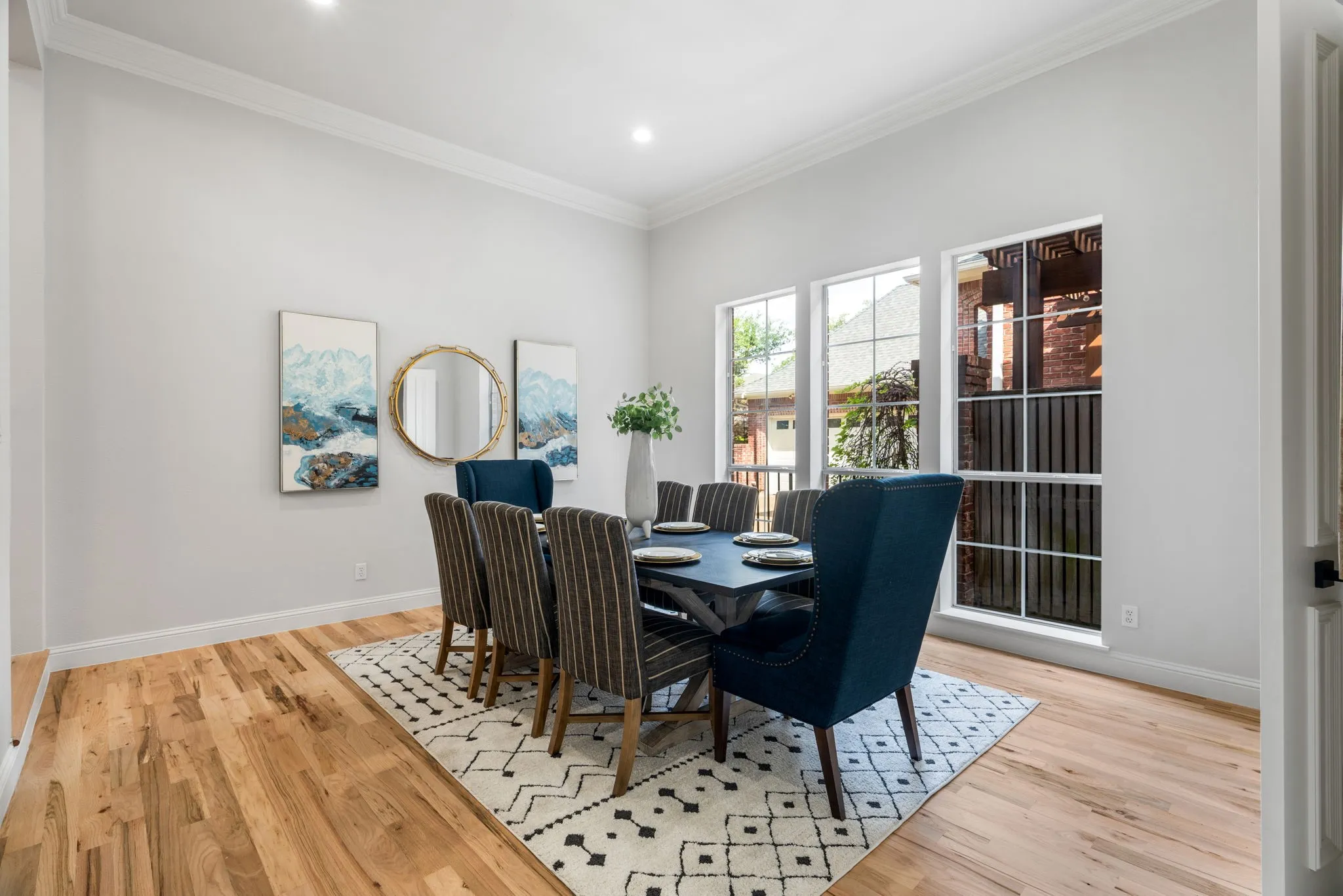 Dining area featuring ornamental molding and light wood finished floors