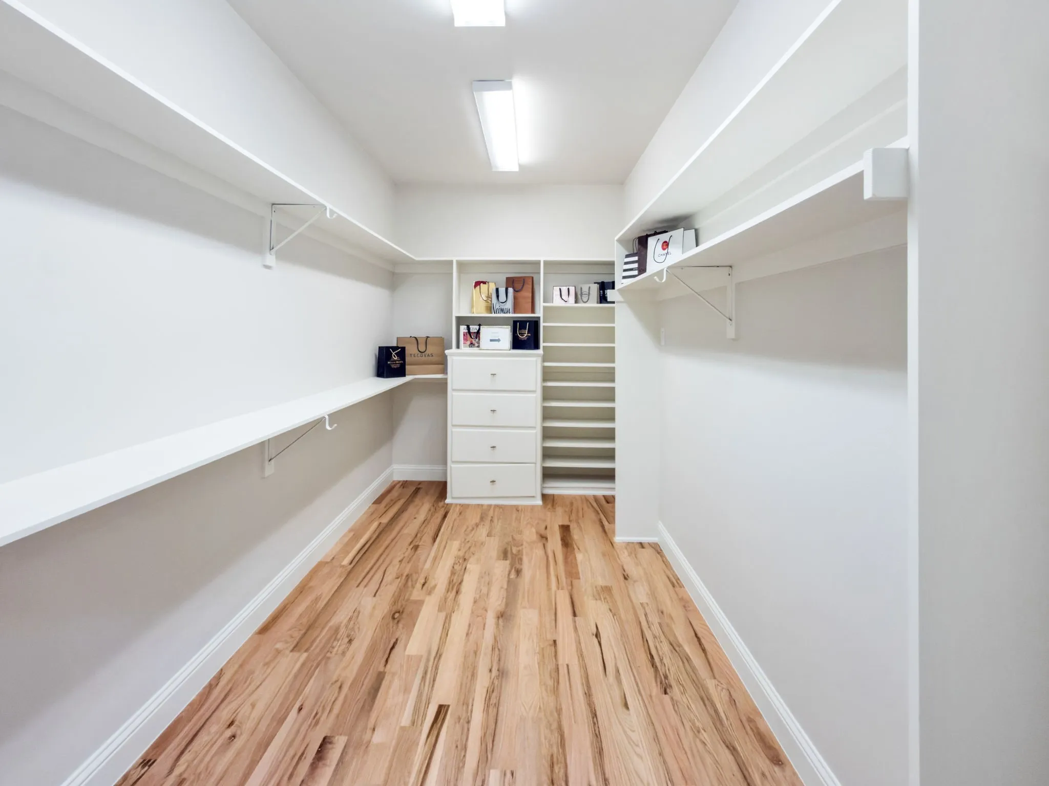 Walk in closet featuring light wood-style floors