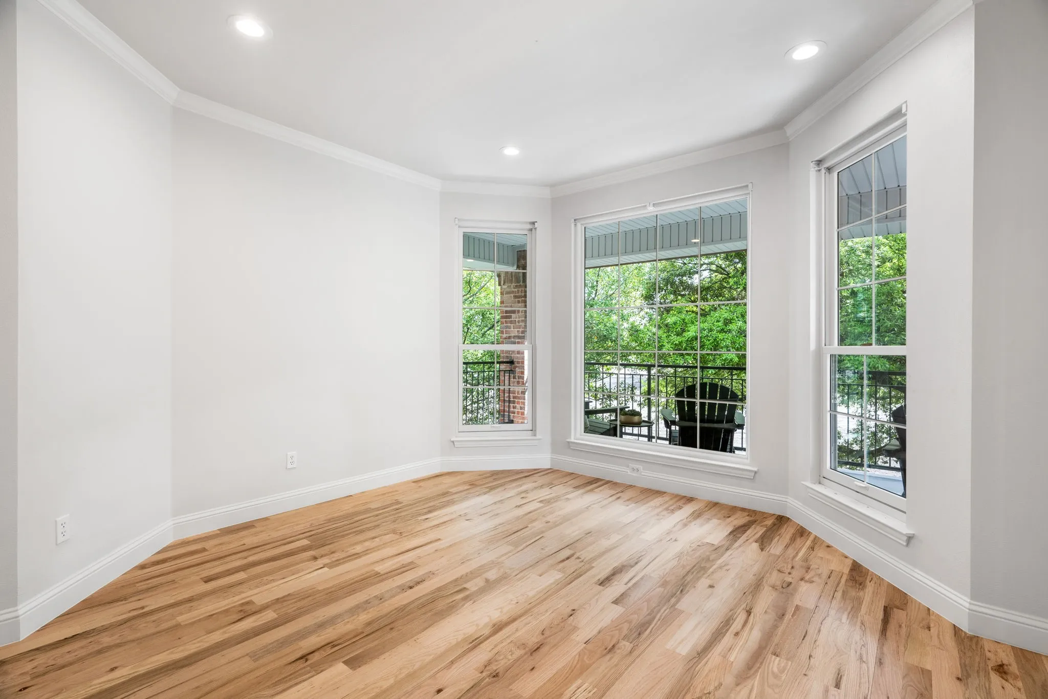 Unfurnished room with ornamental molding, light wood-style flooring, and recessed lighting