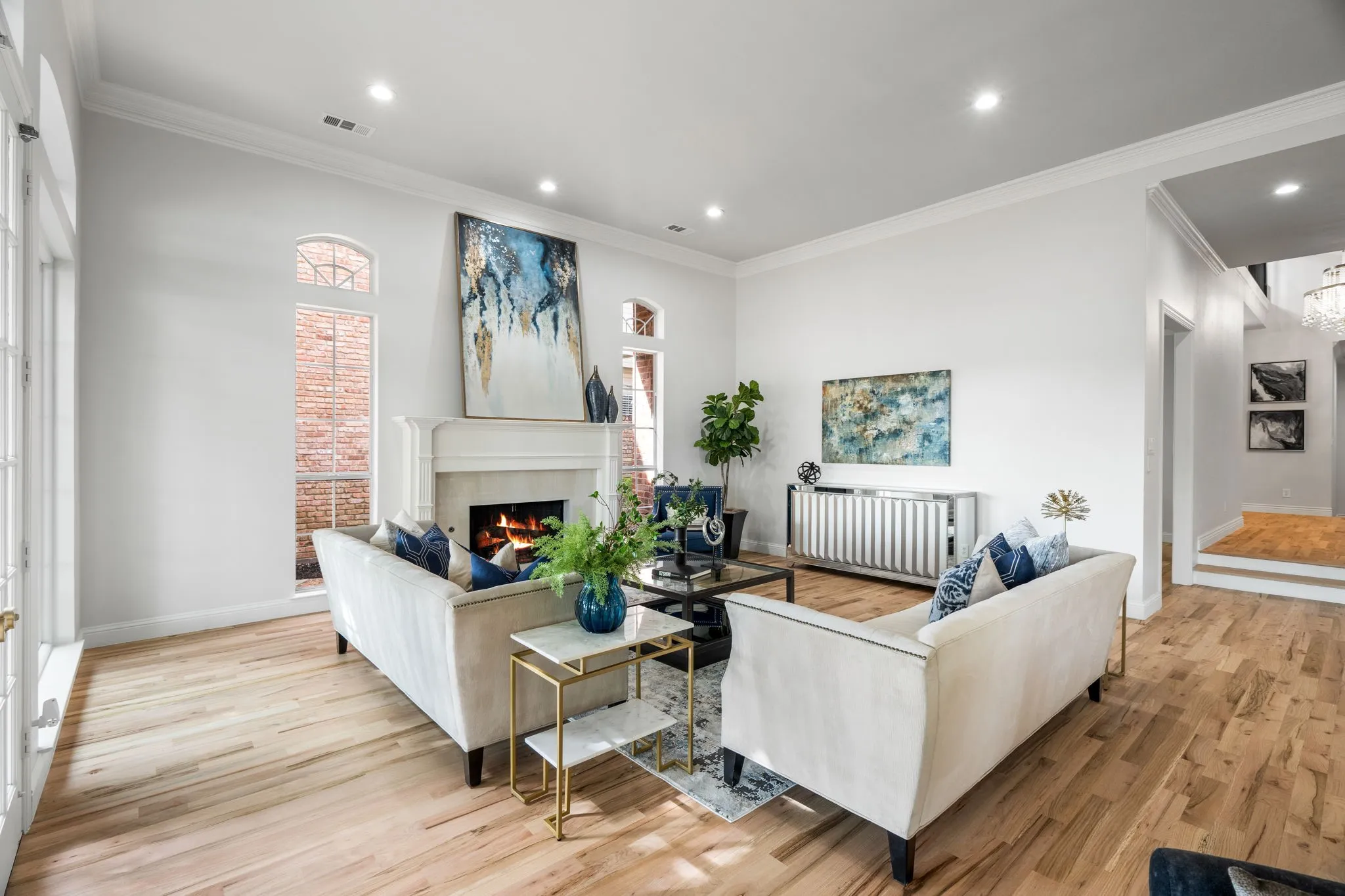 Living area featuring light wood-type flooring, crown molding, a tile fireplace, and recessed lighting
