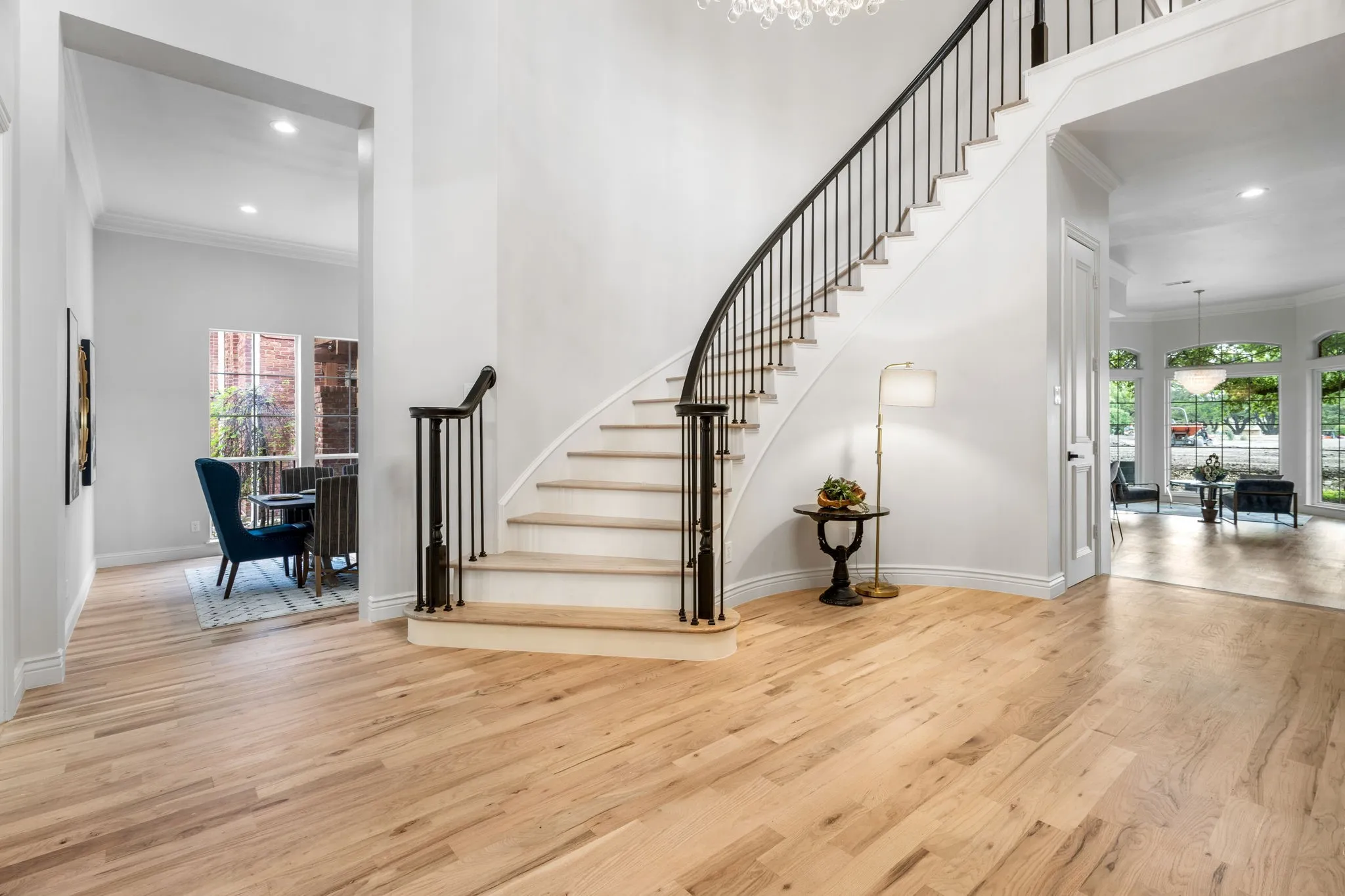 Stairs featuring crown molding, a high ceiling, wood finished floors, and a chandelier