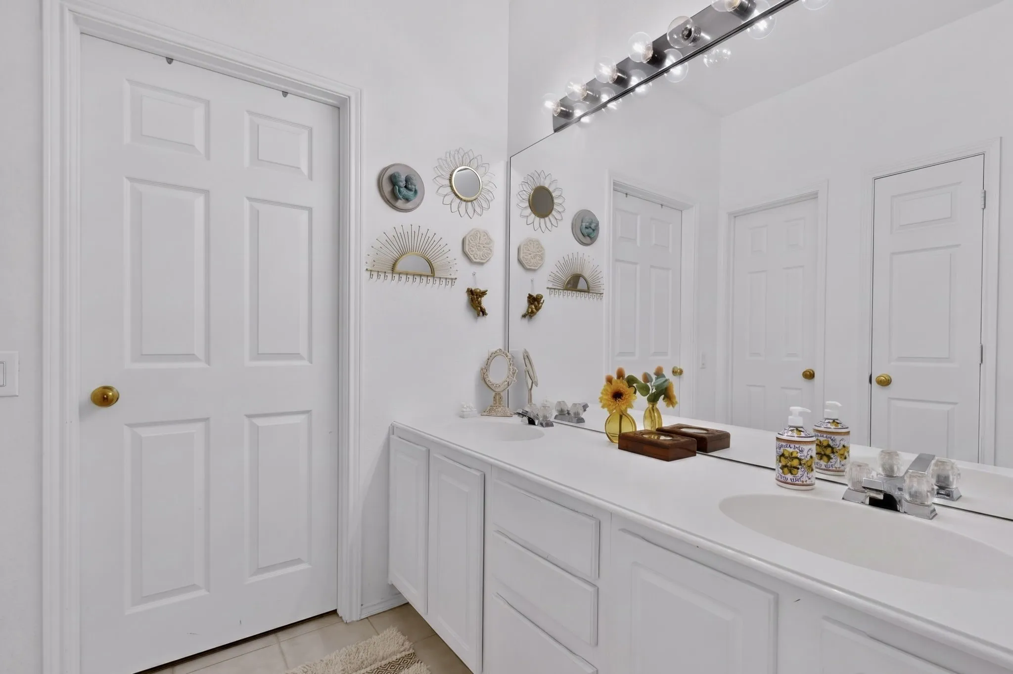 Walk-in closet featuring multiple clothing rods, shelving, and built-in shoe storage