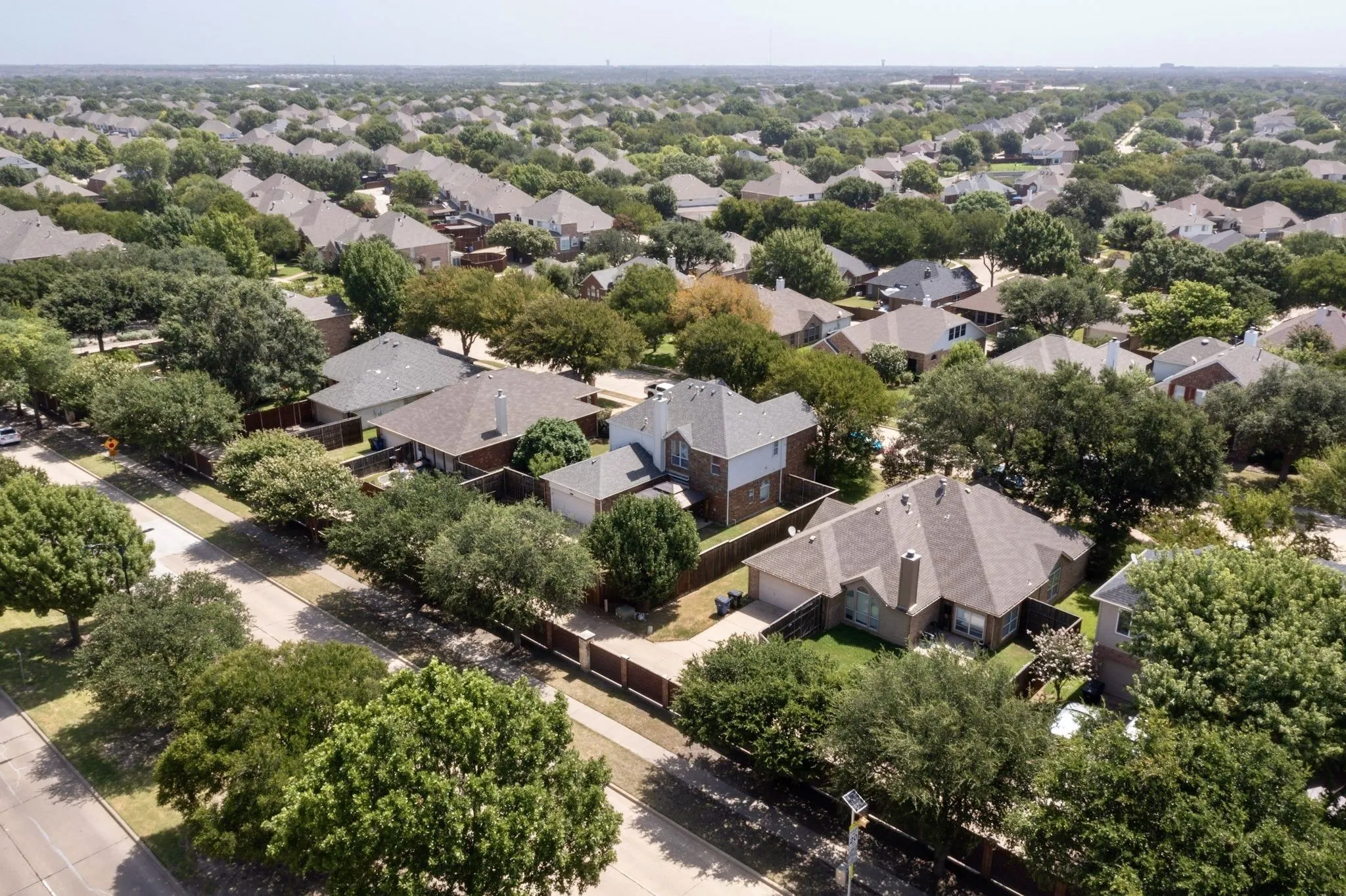 Residential neighborhood featuring mature tree-lined streets and varied architectural styles